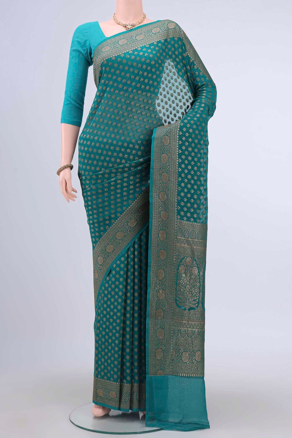 Sea Green Banarasi Georgette Saree with Zari Brocade on the body and Zari Border displayed on a mannequin