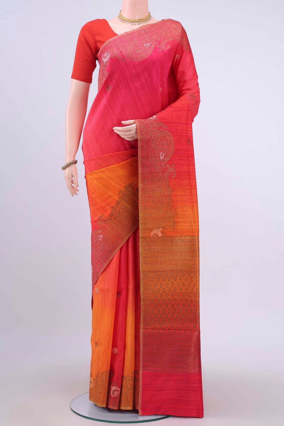 Brick Orange Dual Tone Banarasi Raw Silk Saree with Zari Butta on the body and Zari Border displayed on a mannequin