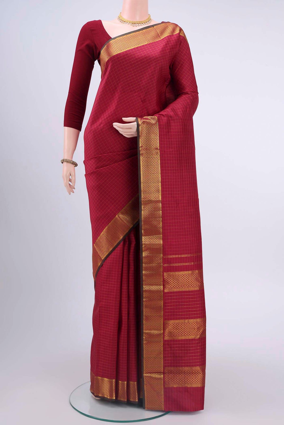 Maroon Kanchipuram Silk Saree with Checked design on the body and Zari Border displayed on a mannequin