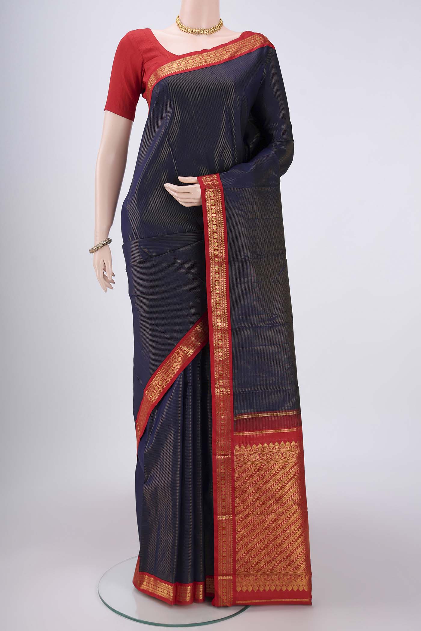 Navy Blue Kanjivaram Saree with Stripes on the body and Temple Border.  displayed on a mannequin