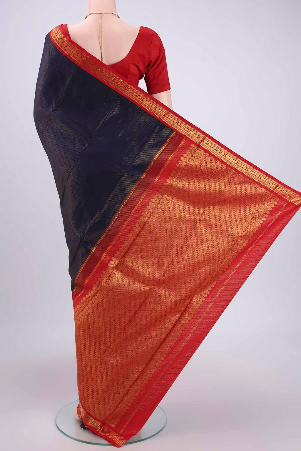 Flat view of Navy Blue Kanjivaram Saree with Stripes on the body and Temple Border. 
