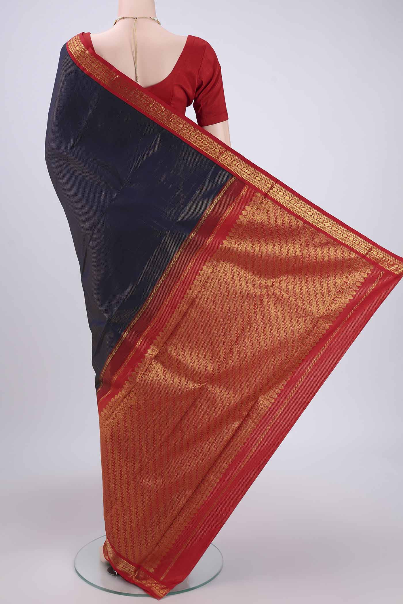 Flat view of Navy Blue Kanjivaram Saree with Stripes on the body and Temple Border. 