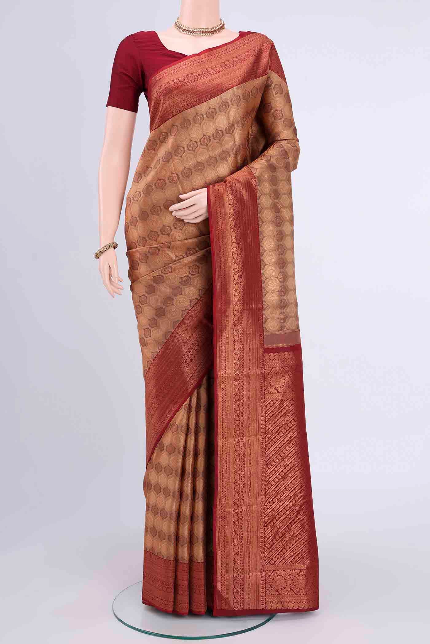 Bronze Kanchipuram Saree with Zari Brocade on the body and Zari Border displayed on a mannequin