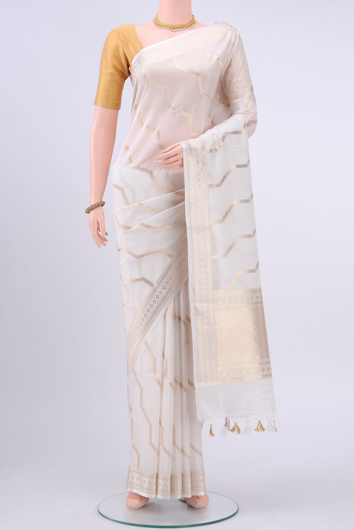 White Dual Tone Banarasi Silk Saree with Zig Zag design on the body and Zari And Thread Border displayed on a mannequin