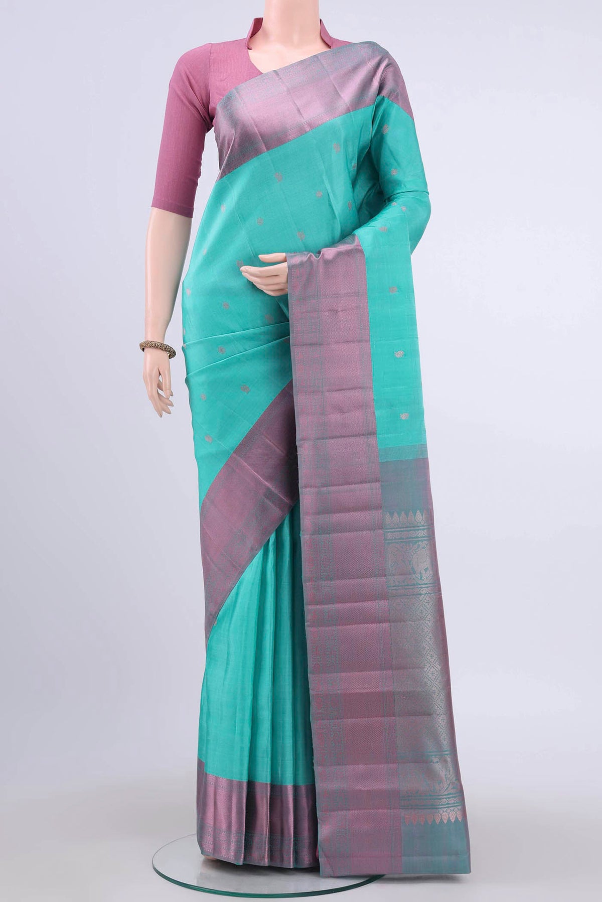Turquoise Kanchipuram Silk Saree with Thread Butta on the body and Thread Border displayed on a mannequin