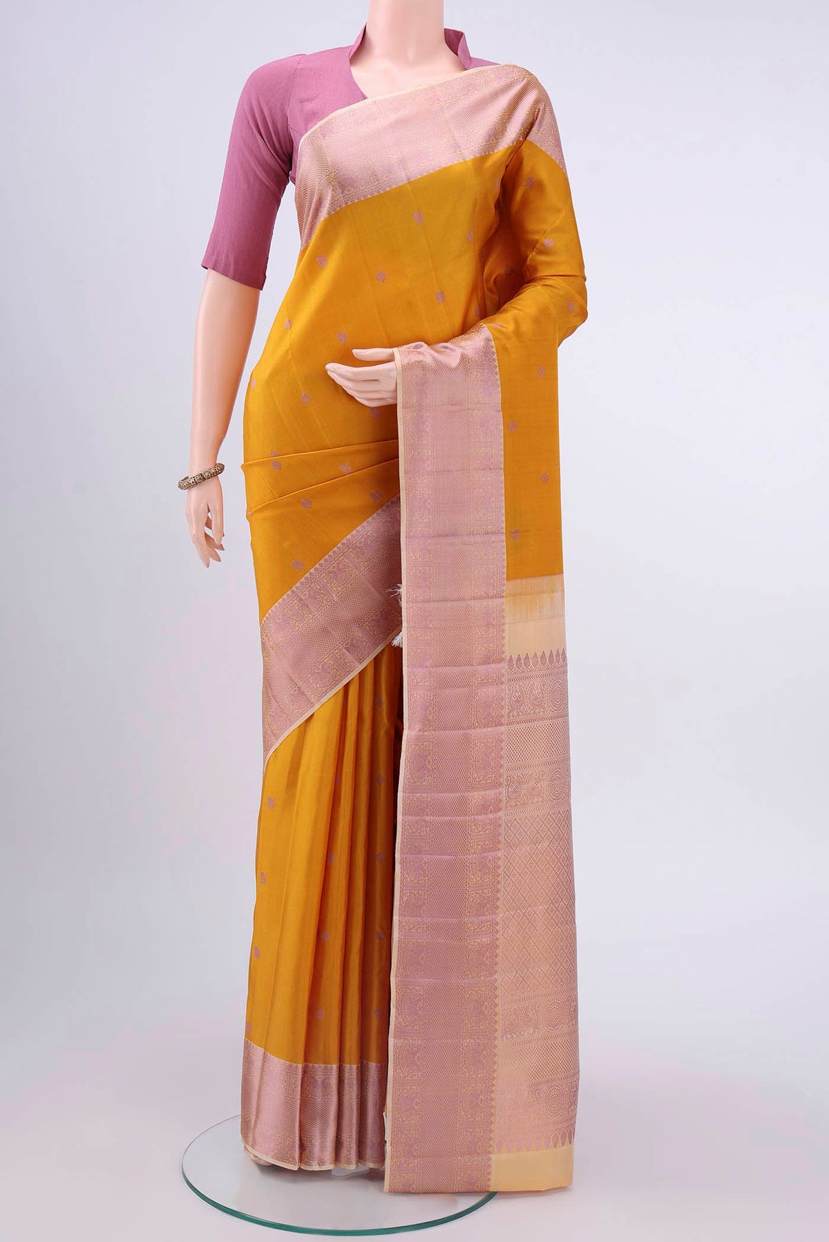 Yellow Kanchipuram Silk Saree with Thread Butta on the body and Thread Border displayed on a mannequin