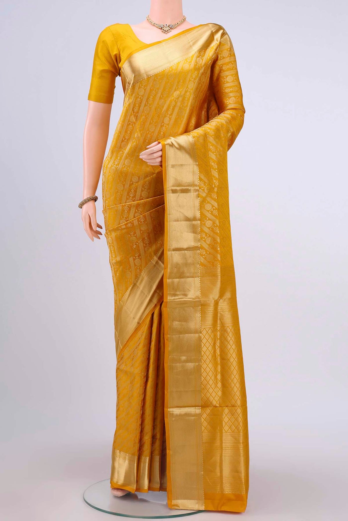 Yellow Dual Tone Soft Silk Saree with Zari Brocade on the body and Zari Border displayed on a mannequin