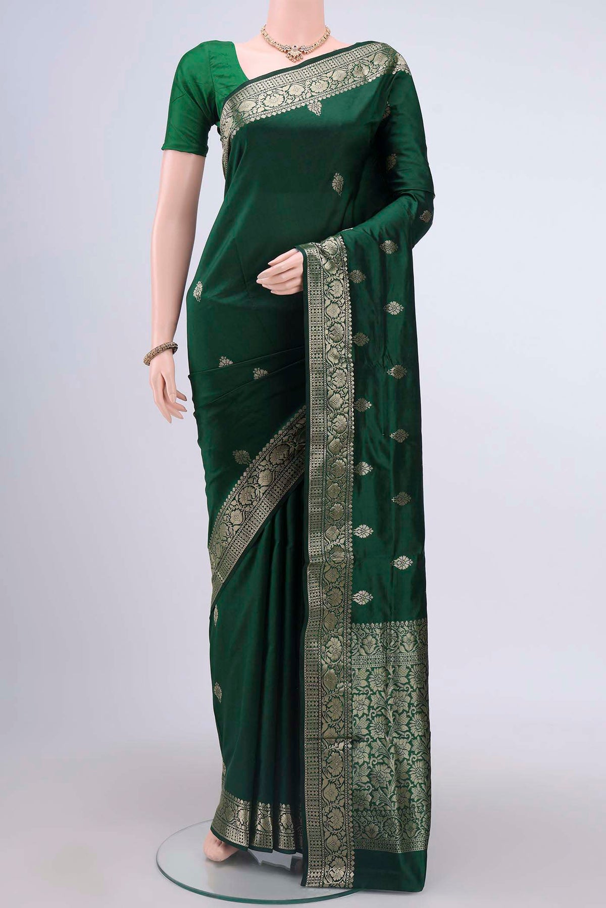 Bottle Green Dual Tone Banarasi Katan Silk Saree with Zari Butta on the body and Zari Border displayed on a mannequin