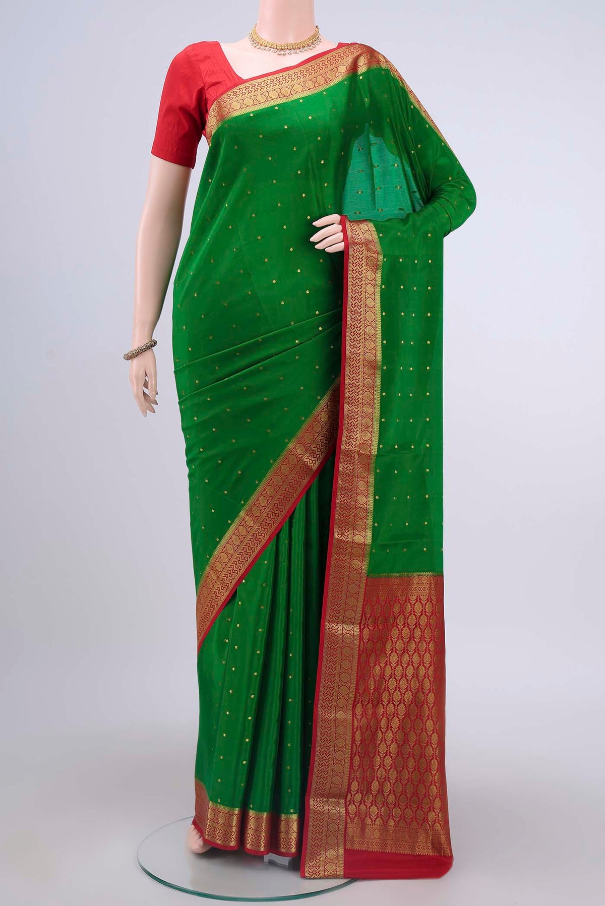 Green Mysore Crepe Saree with Zari Butta on the body and Zari Border displayed on a mannequin