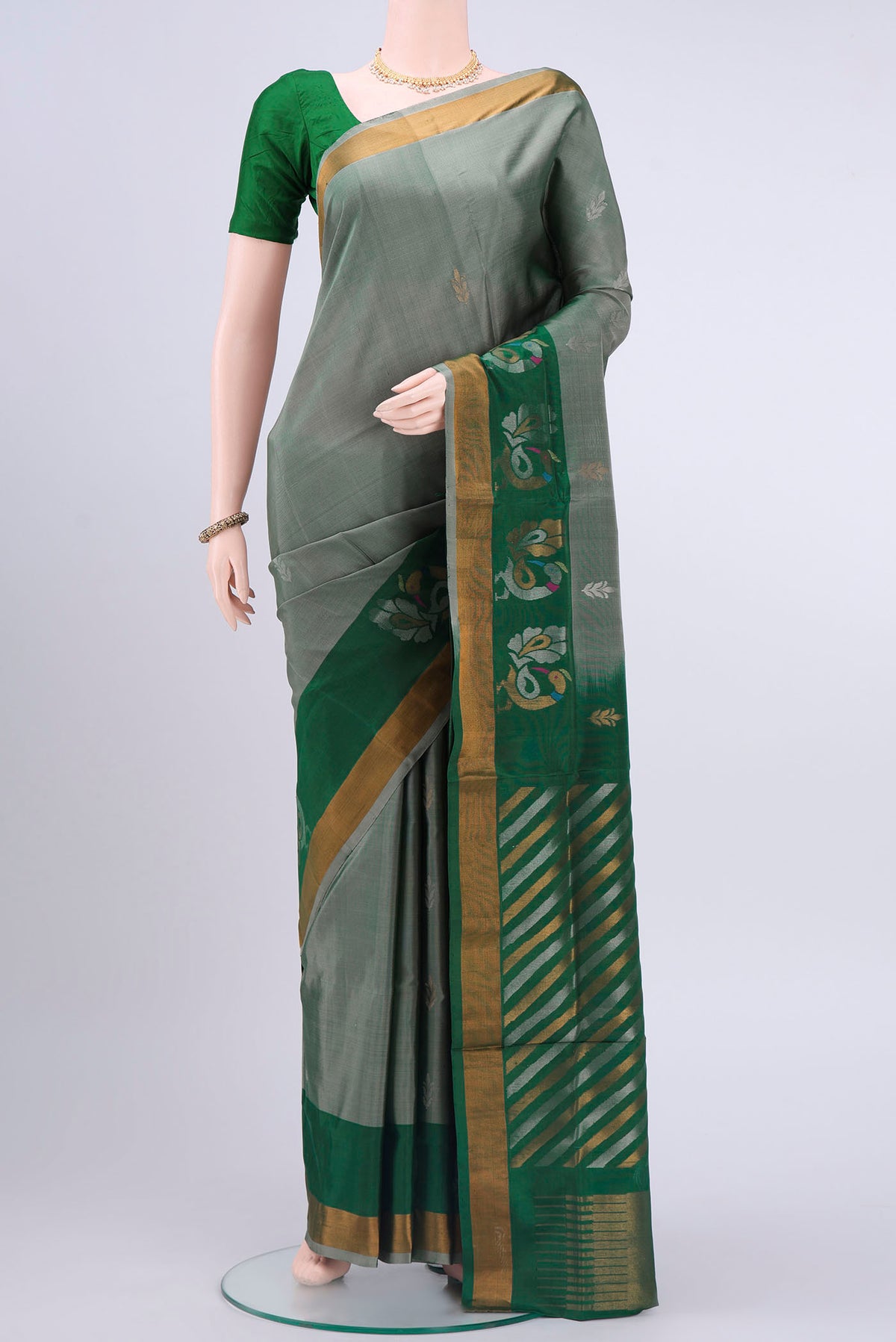 Grey Uppada Silk Saree with Zari Butta on the body and Zari Border displayed on a mannequin