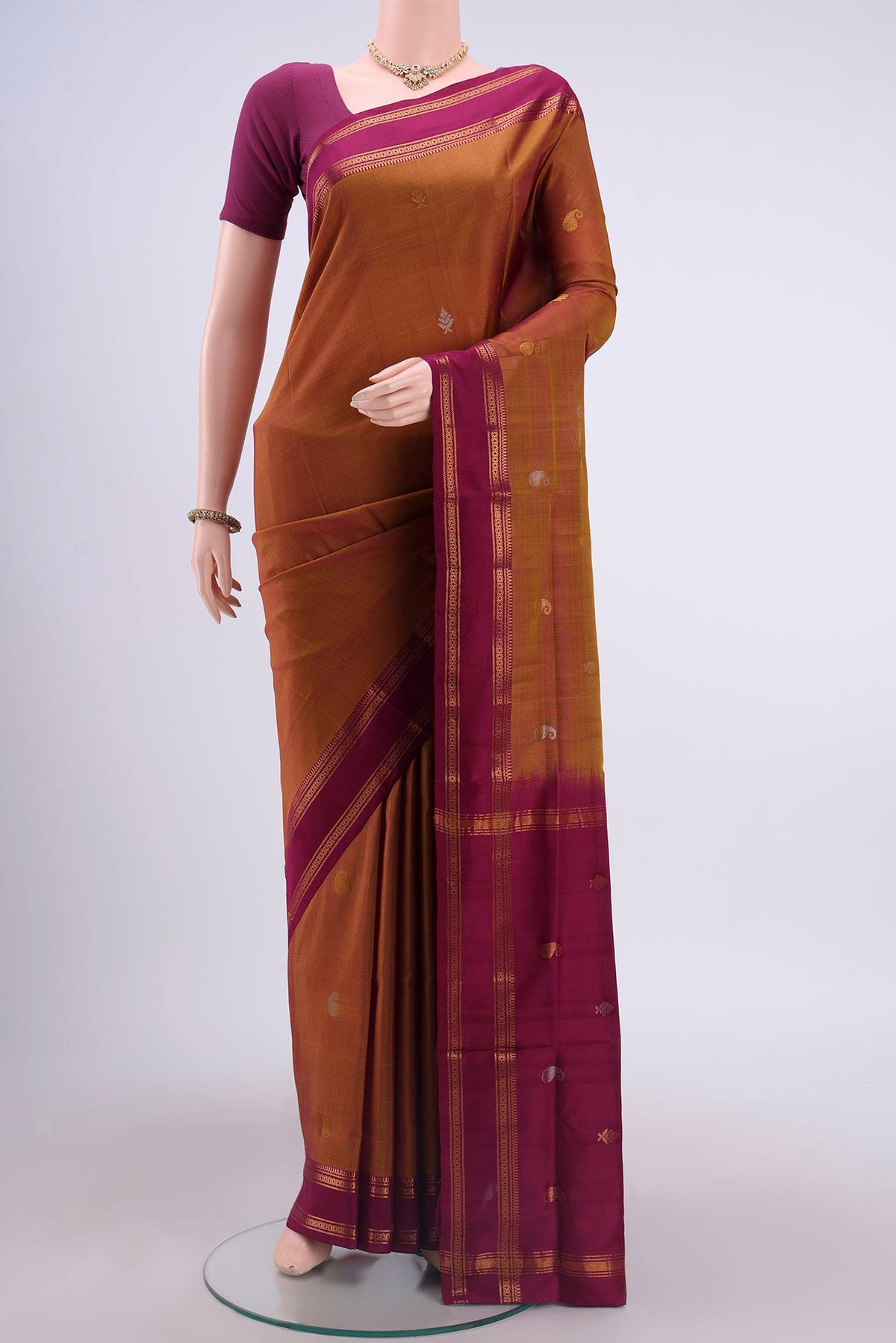 Mustard Uppada Silk Saree with Zari Butta on the body and Zari Border displayed on a mannequin