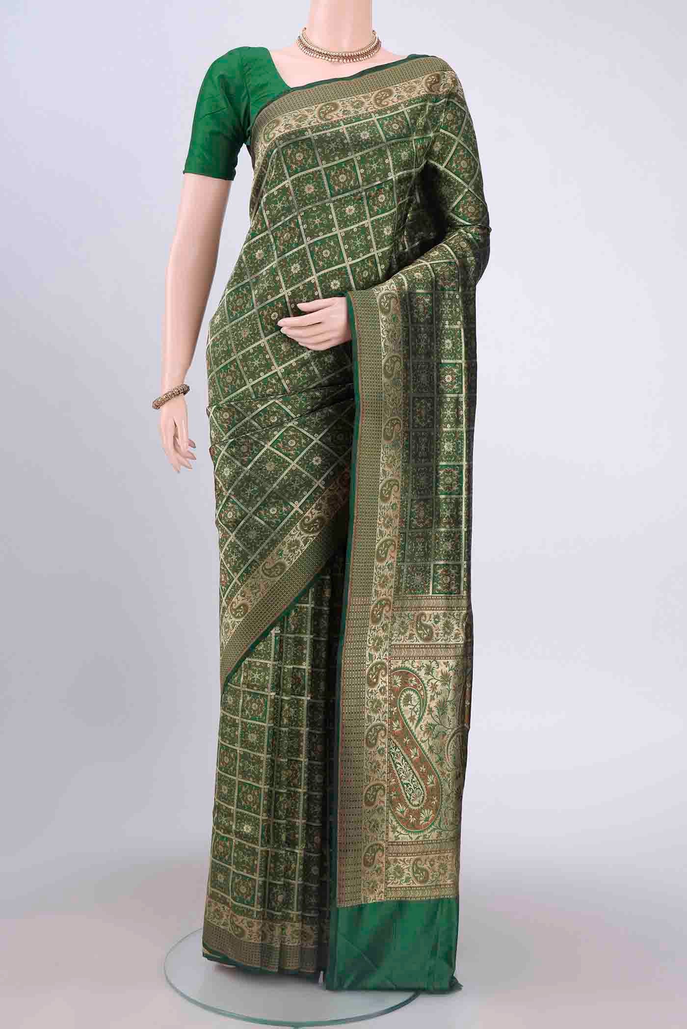 Bottle Green Banarasi Jamavar Saree with Checked design on the body and Zari And Thread Border displayed on a mannequin