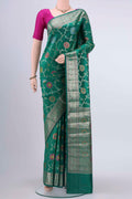 Green Banarasi Raw Silk Saree with Zari And Thread Butta on the body and Zari Border displayed on a mannequin