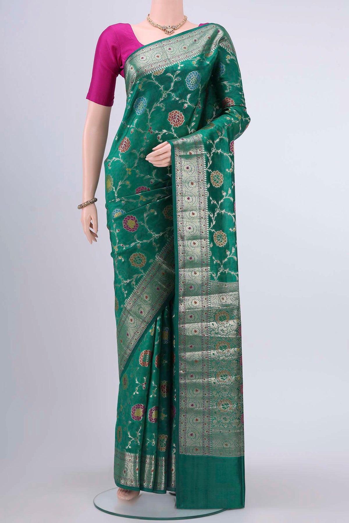 Green Banarasi Raw Silk Saree with Zari And Thread Butta on the body and Zari Border displayed on a mannequin