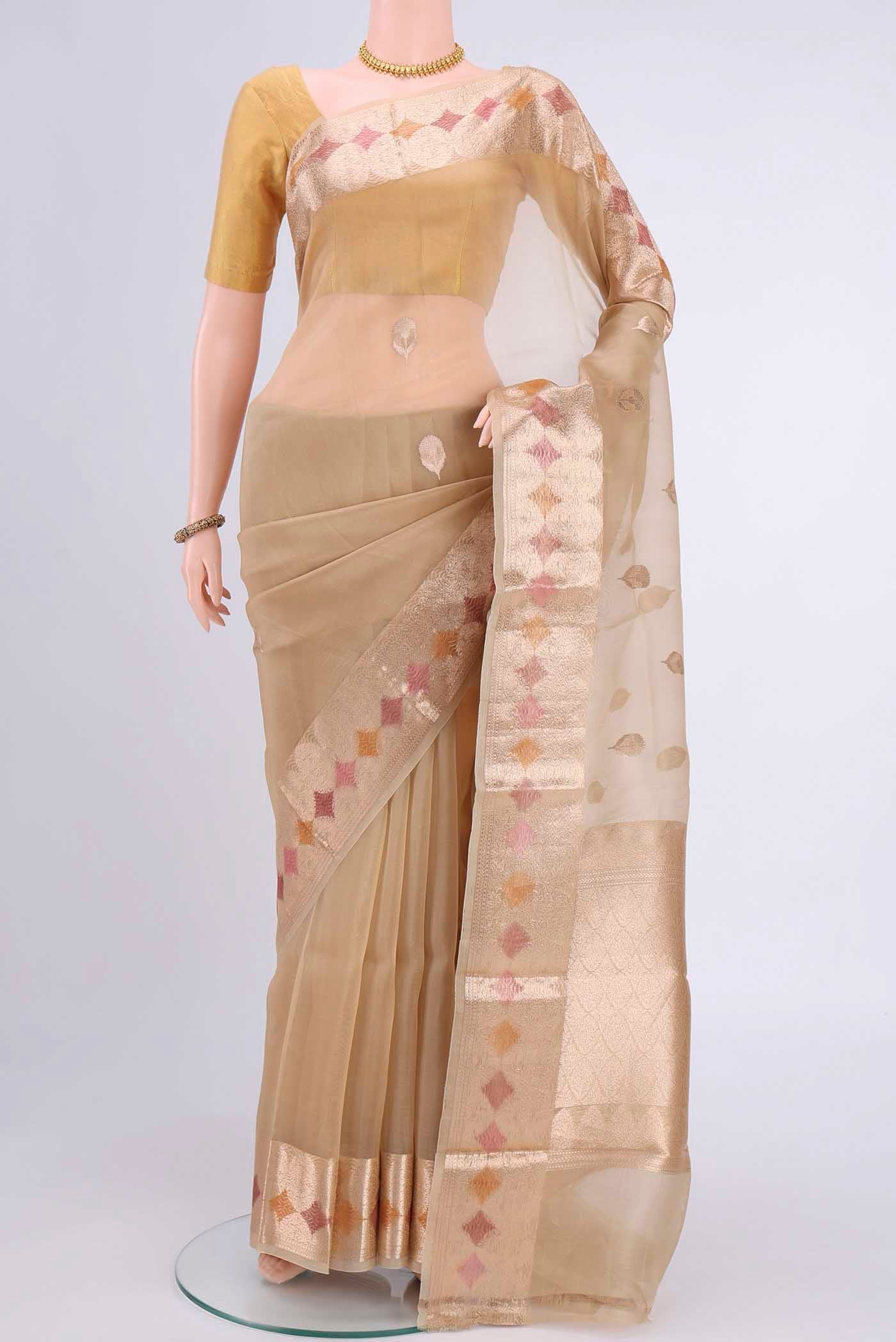 Beige Organza Silk Saree with Zari Butta on the body and Zari Border displayed on a mannequin