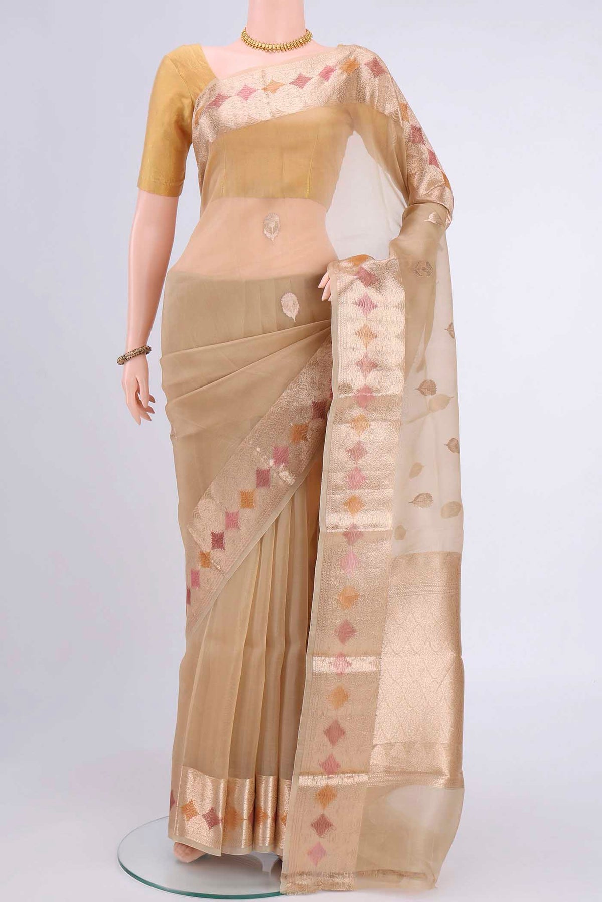 Beige Organza Silk Saree with Zari Butta on the body and Zari Border displayed on a mannequin