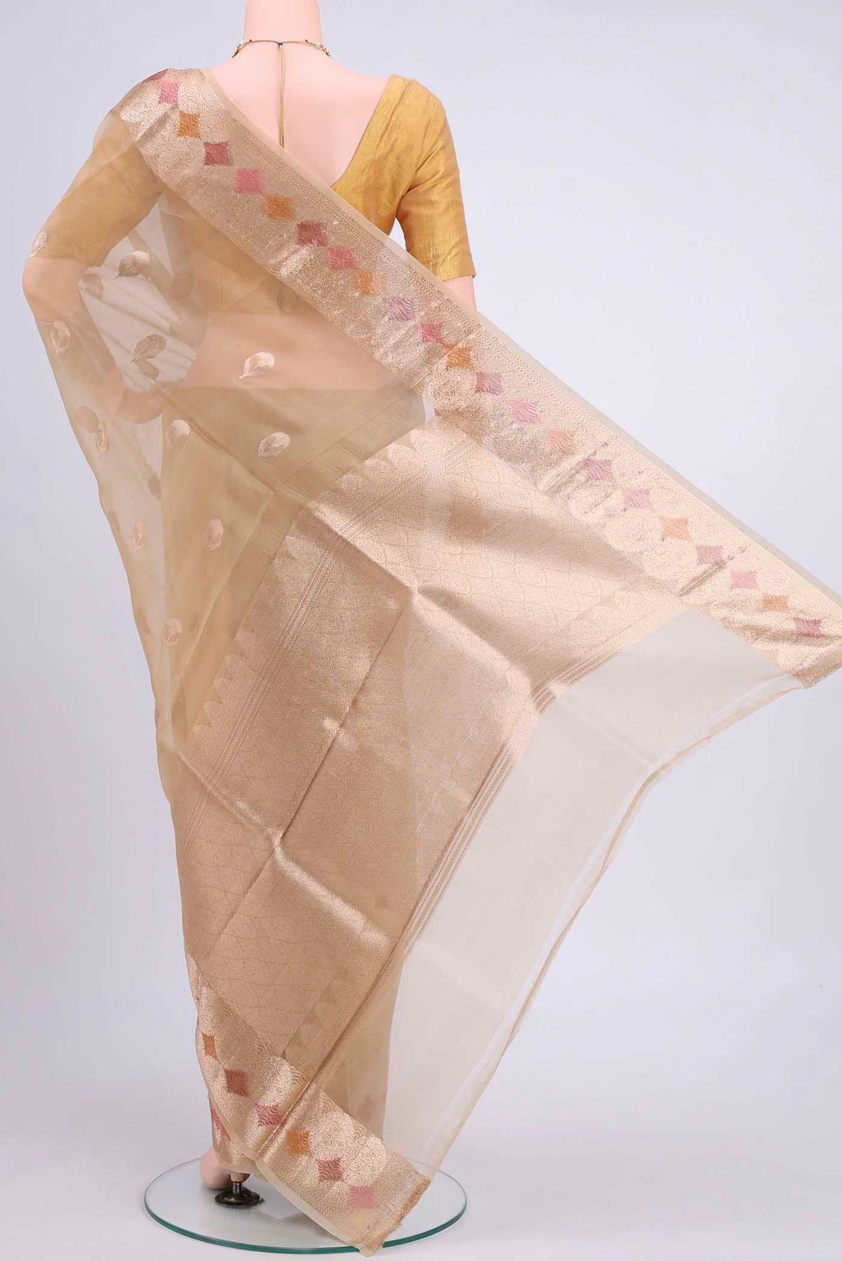 Flat view of Beige Organza Silk Saree with Zari Butta on the body and Zari Border