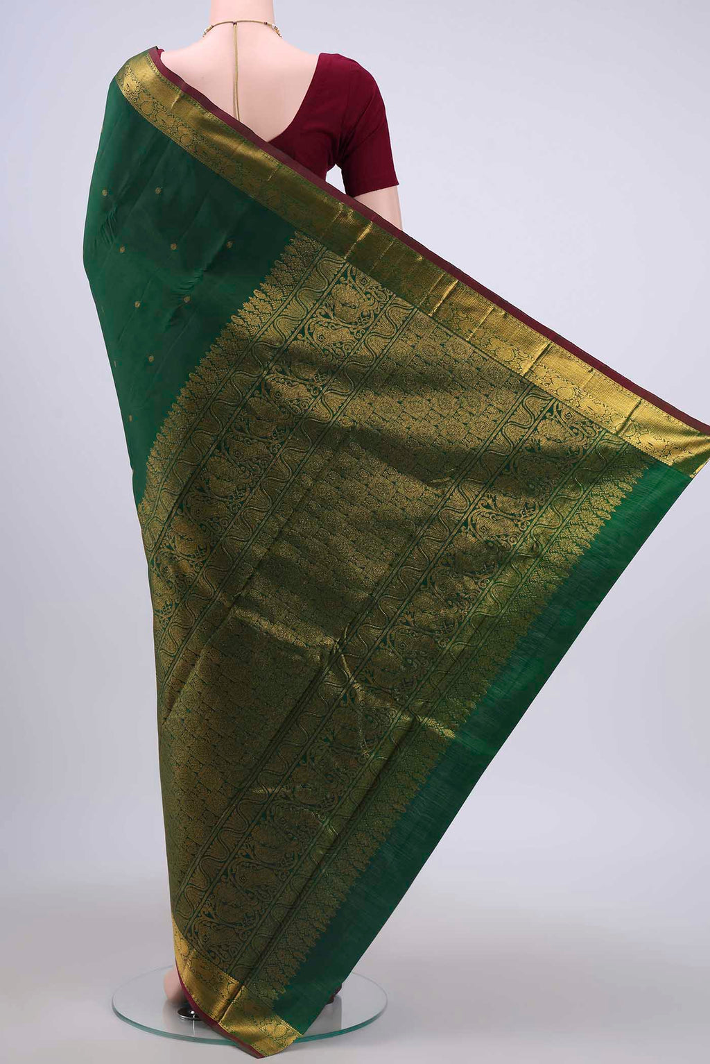 Flat view of Bottle Green Kanchipuram Saree with Zari Butta on the body and Zari Border