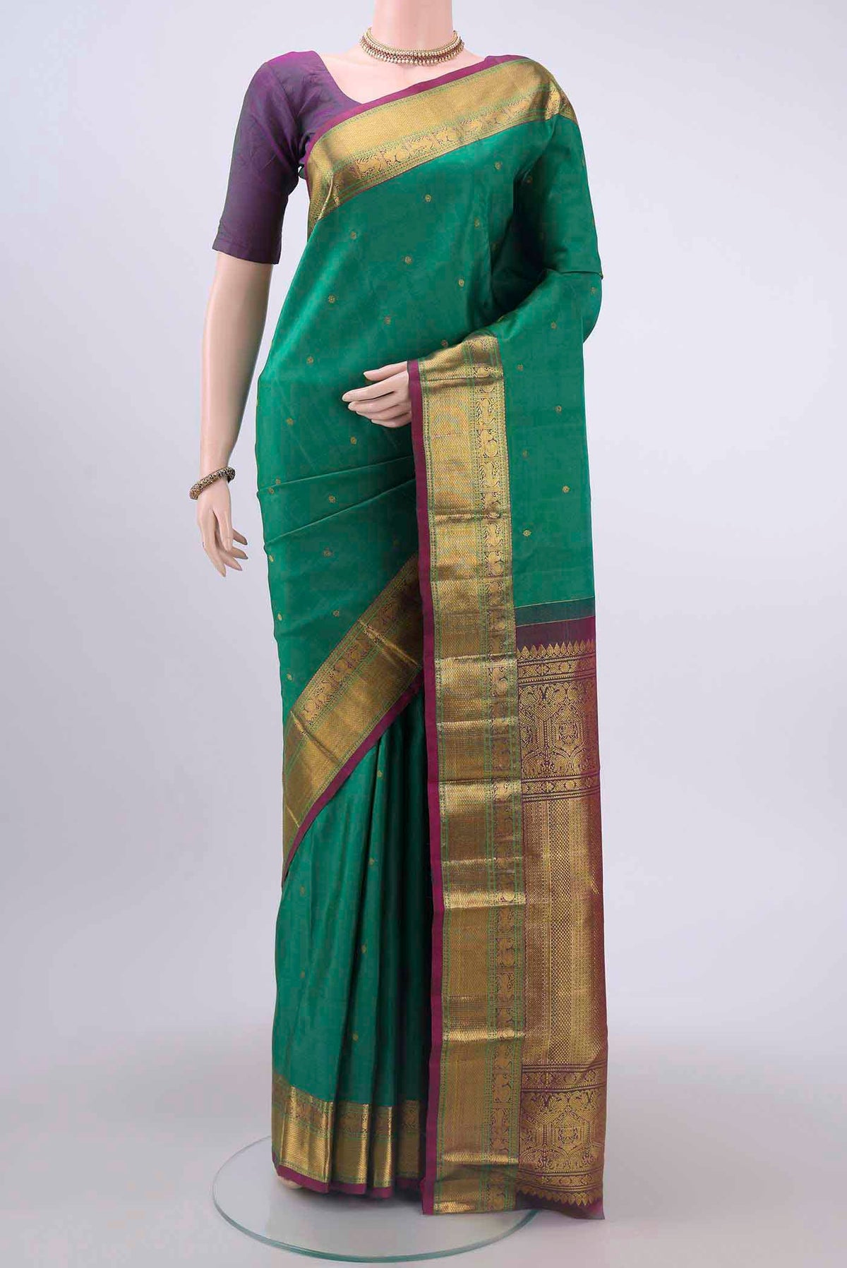 Green Dual Tone Kanchipuram Saree with Zari Butta on the body and Zari Border displayed on a mannequin