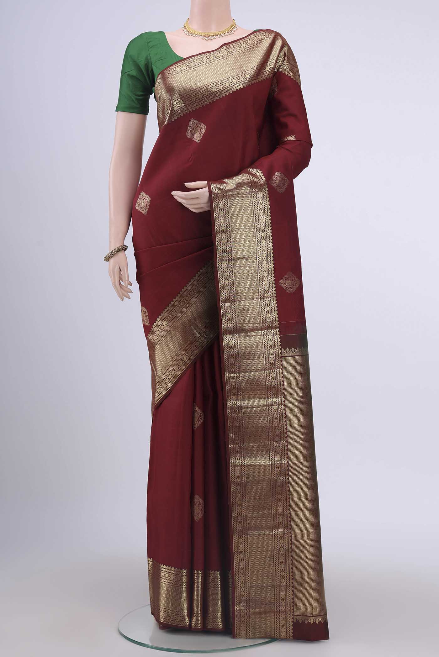 Maroon Kanchipuram Saree with Zari Butta on the body and Zari Border displayed on a mannequin