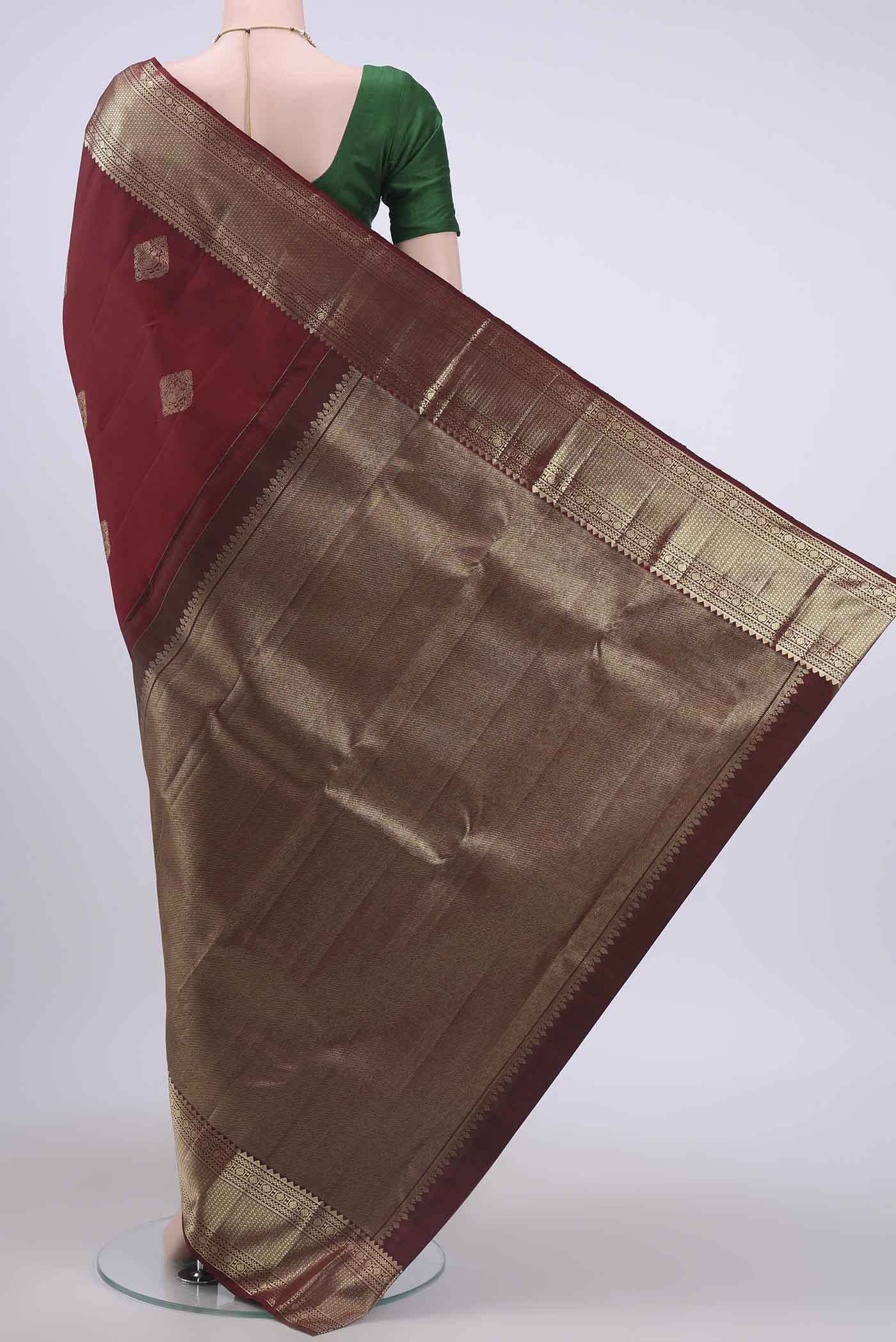 Flat view of Maroon Kanchipuram Saree with Zari Butta on the body and Zari Border