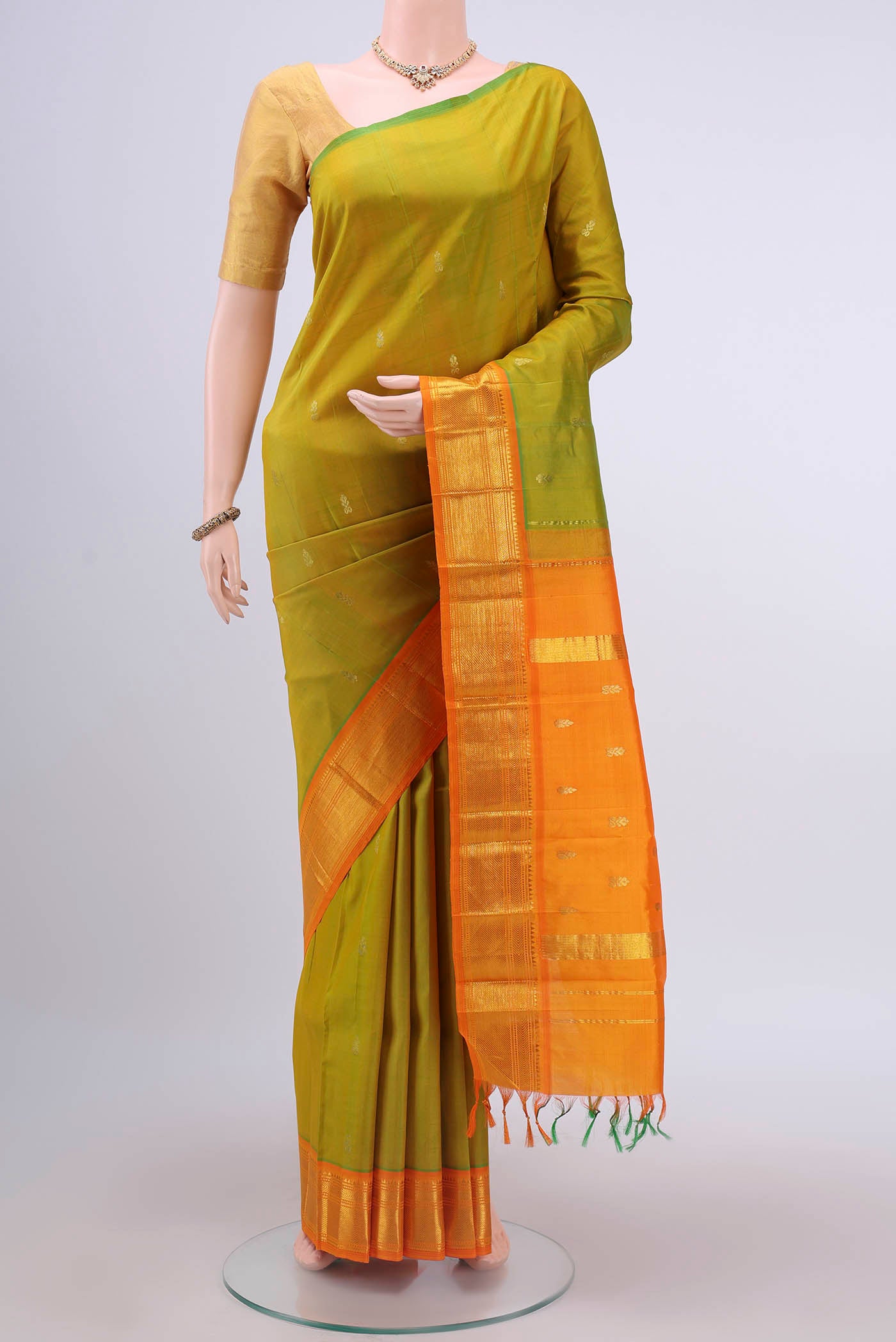 Light Green Dual Tone Kanchipuram Silk Saree with Zari Butta on the body and One Side Border displayed on a mannequin