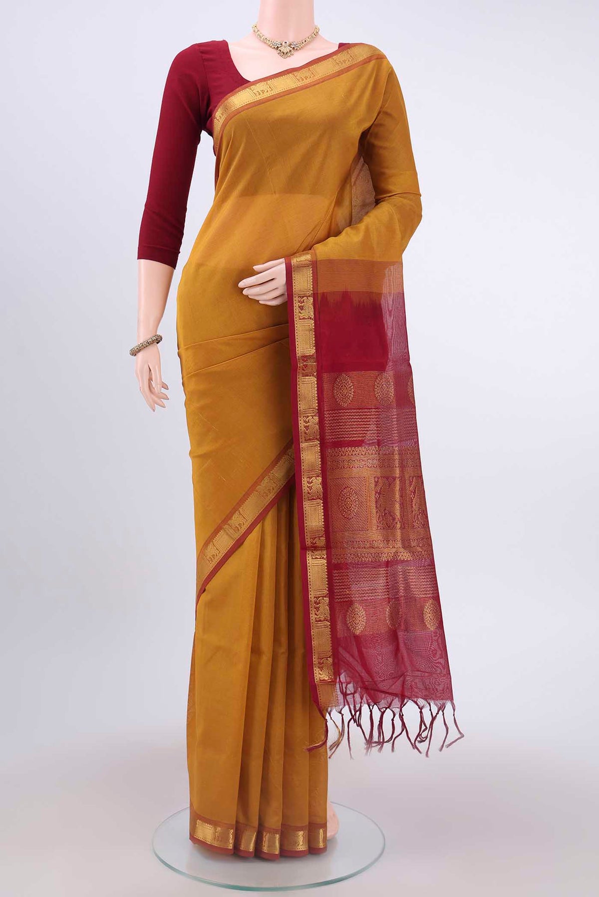 Mustard Blended Coimbatore Silk Cotton Saree with Plain Body and Zari Border displayed on a mannequin