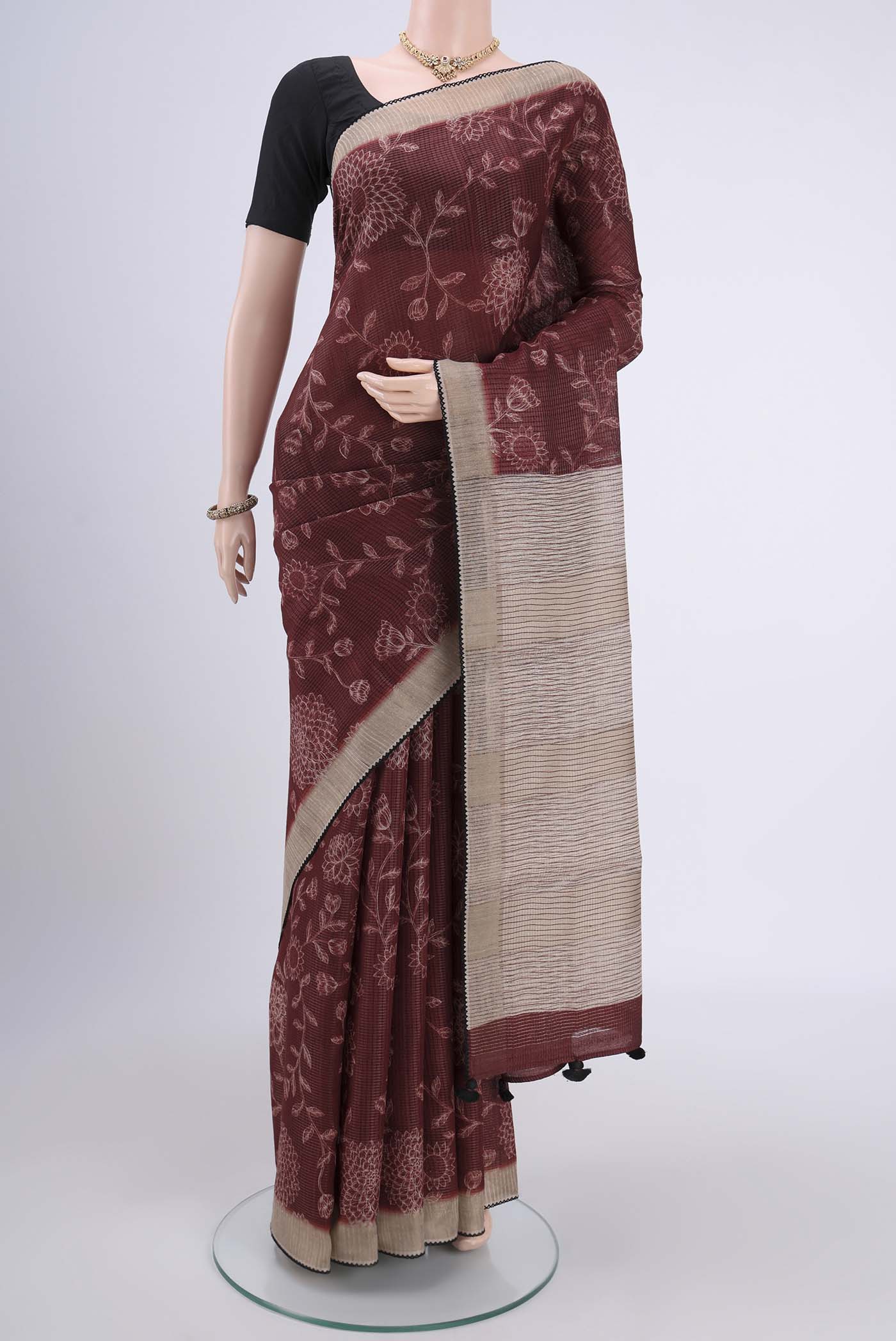 Brown Tussar Silk Saree with Printed design on the body and Fancy Border.  displayed on a mannequin
