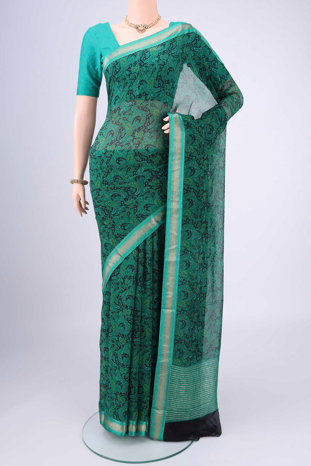 Sea Green Mysore Crepe Saree with Floral Print on the body and Zari Border.  displayed on a mannequin