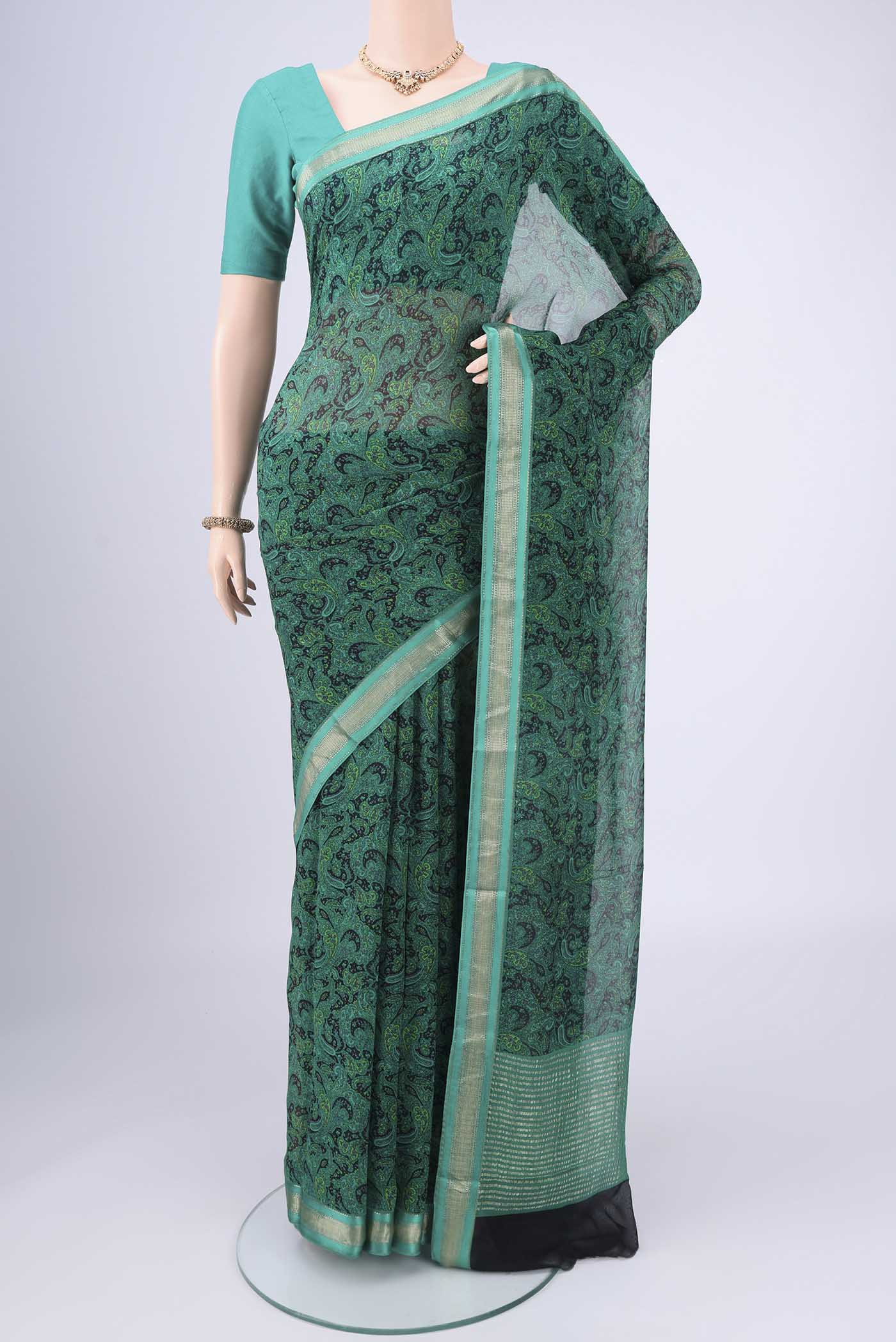 Sea Green Mysore Crepe Saree with Floral Print on the body and Zari Border.  displayed on a mannequin