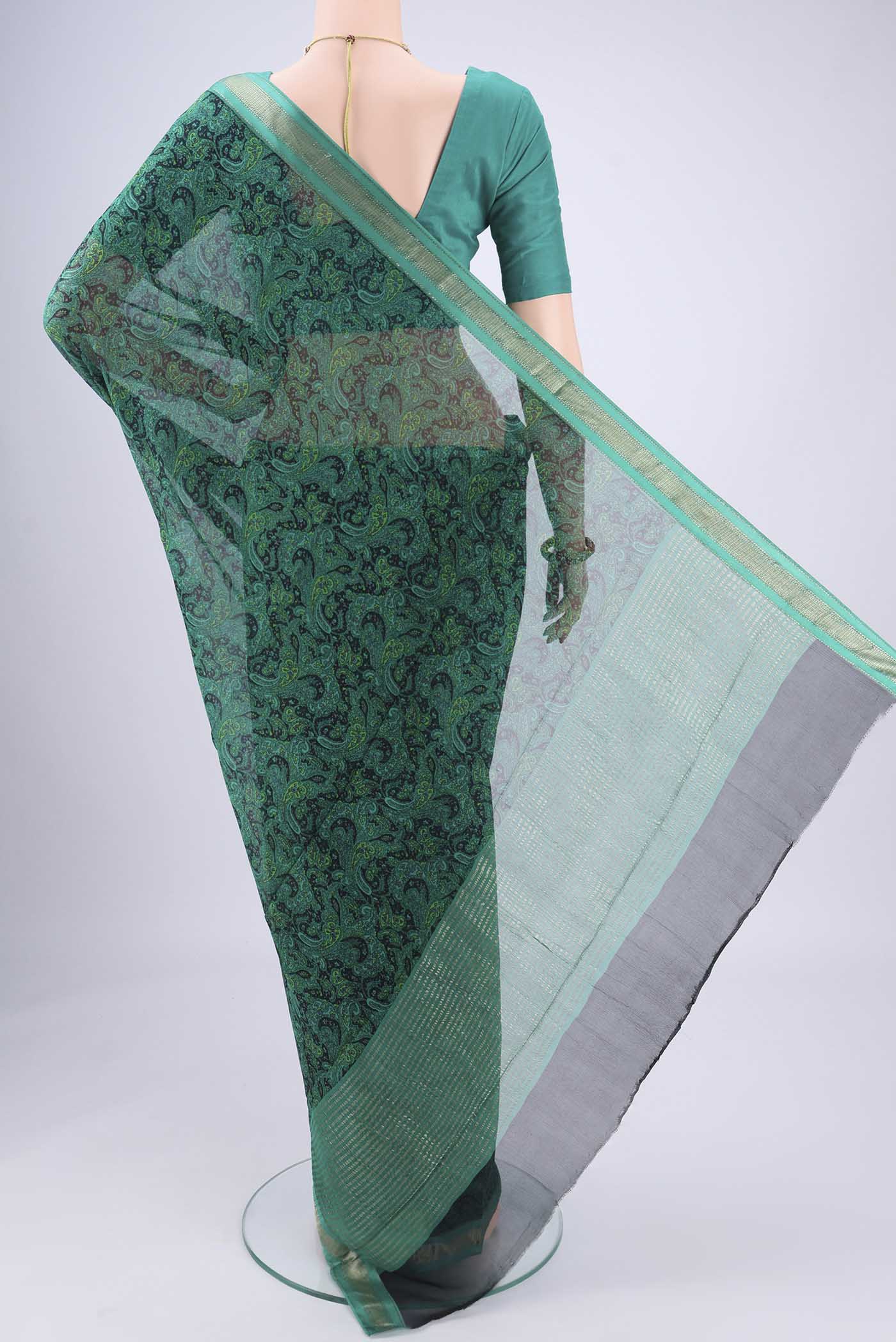 Flat view of Sea Green Mysore Crepe Saree with Floral Print on the body and Zari Border. 