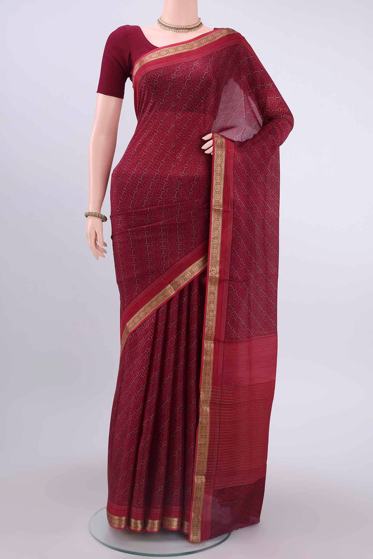 Magenta Mysore Crepe Saree with Floral Print on the body and Zari Border displayed on a mannequin