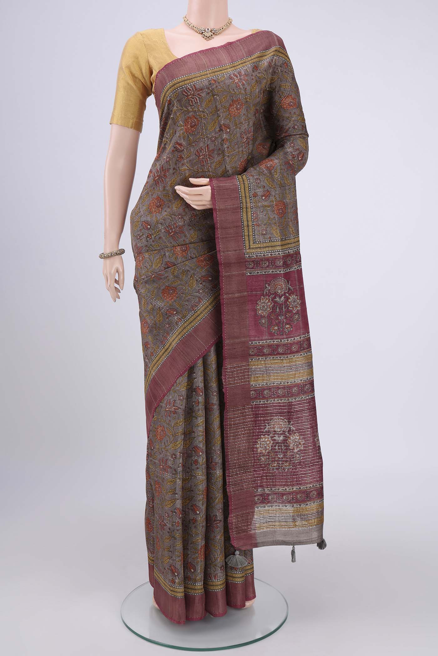 Davys Grey Tussar Silk Saree with Printed design on the body and Fancy Border.  displayed on a mannequin