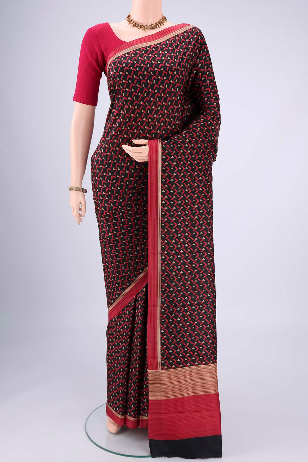 Black Printed Silk Saree with Floral Print on the body and Printed Border.  displayed on a mannequin