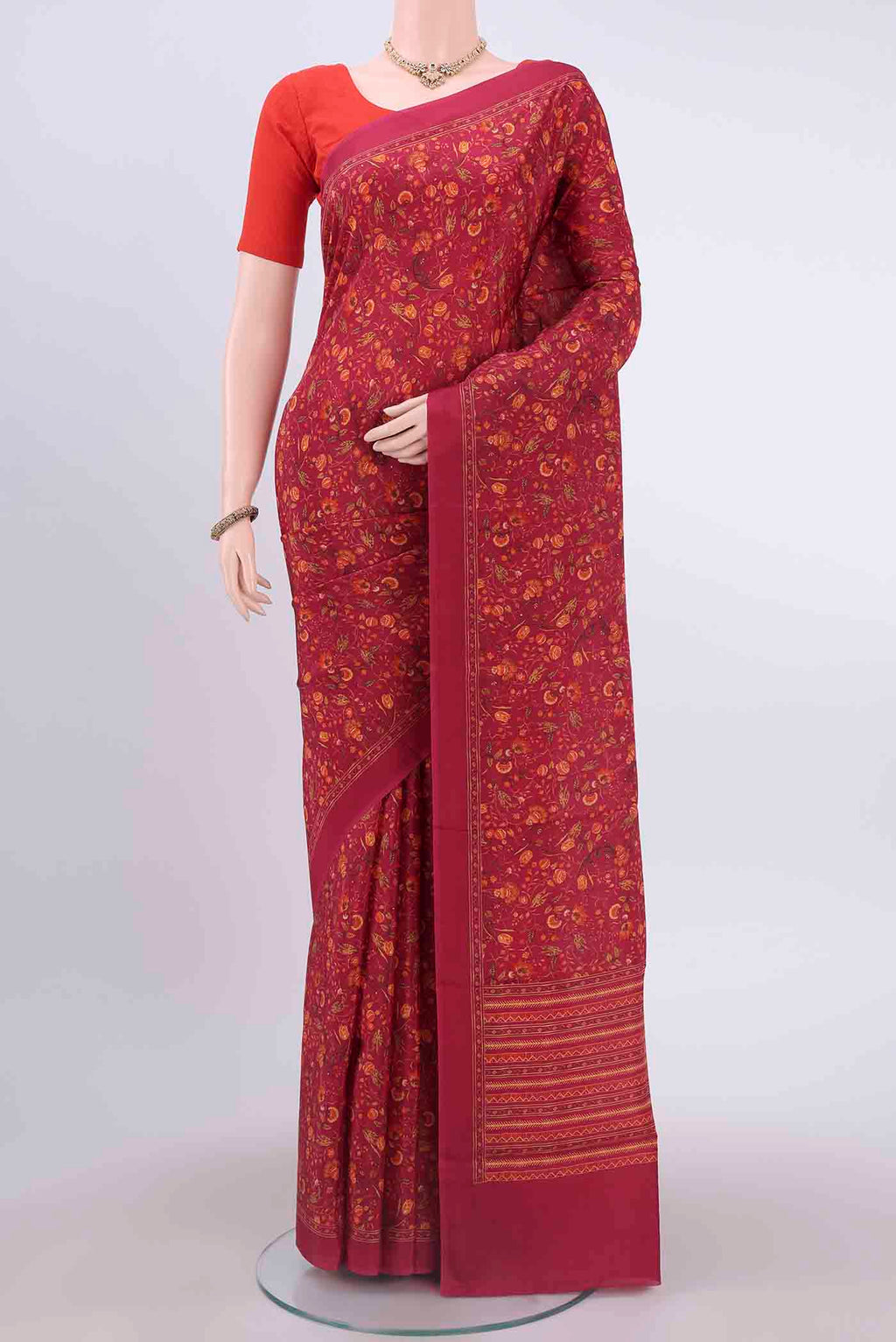 Maroon Printed Silk Saree with Floral Print on the body and Plain Border displayed on a mannequin