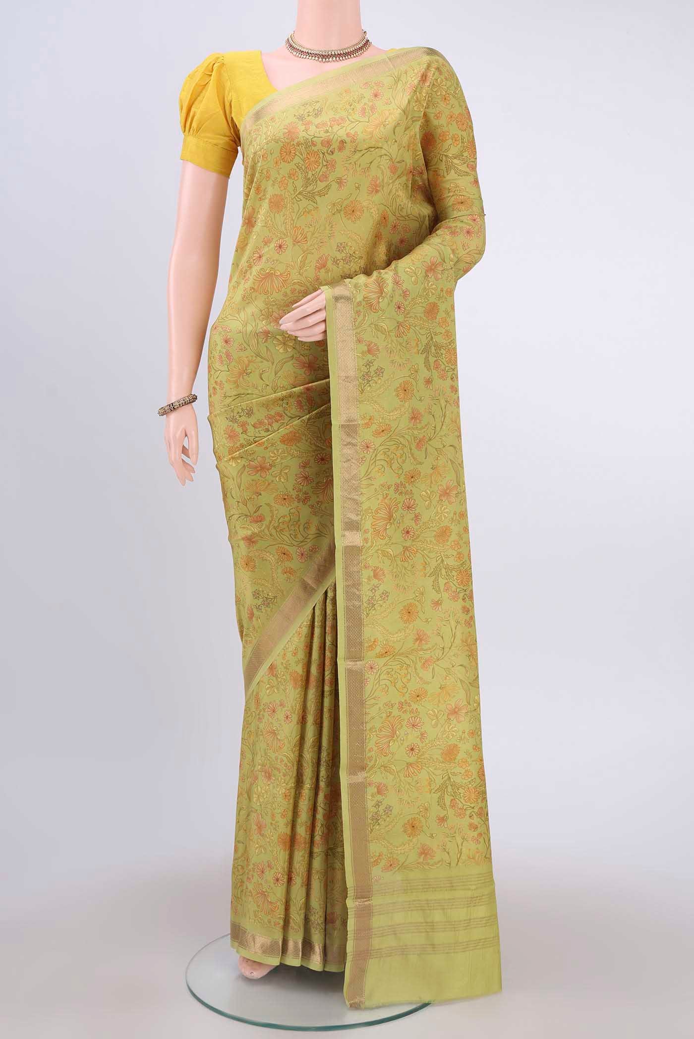 Light Green Printed Silk Saree with Floral Print on the body and Zari Border displayed on a mannequin