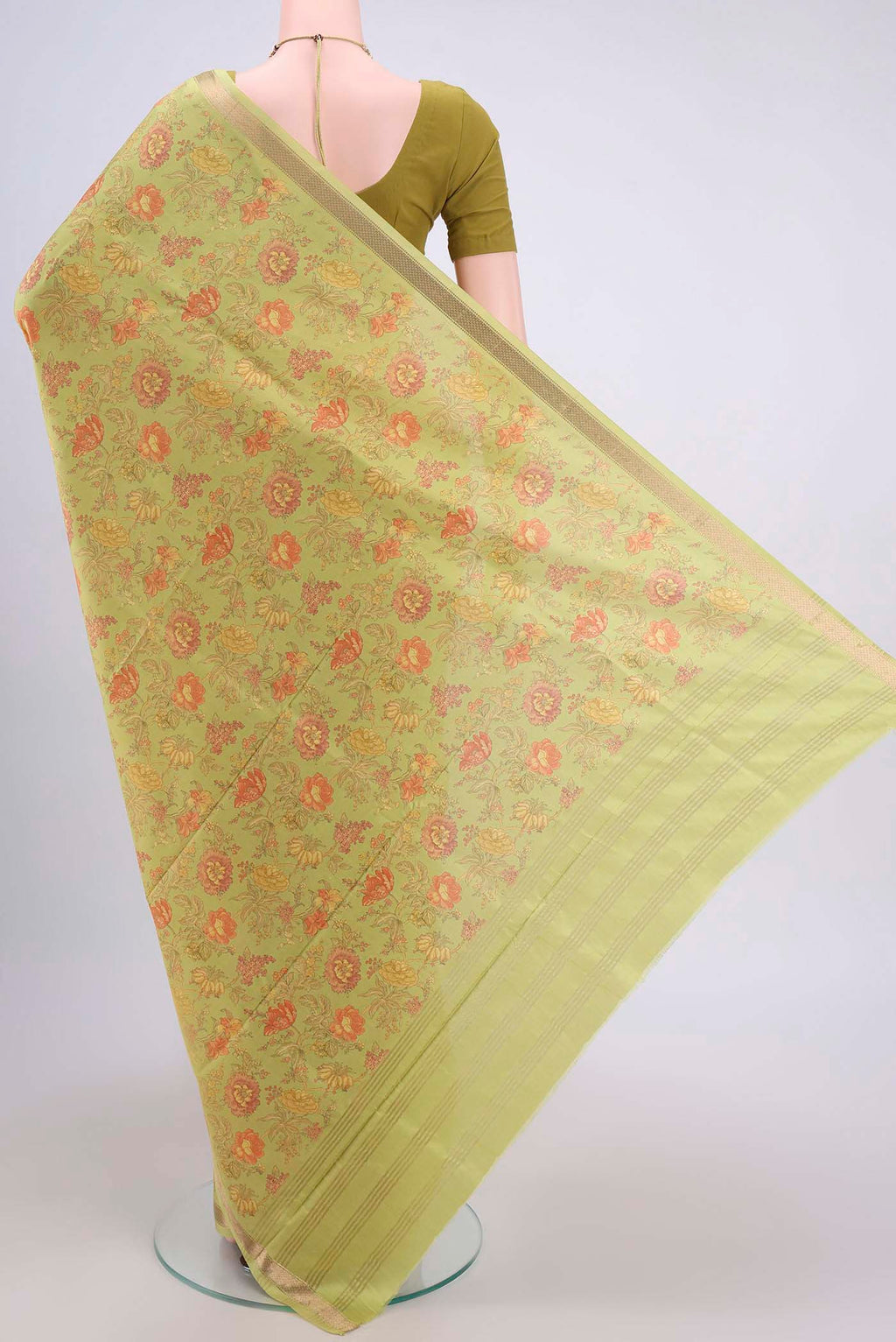 Flat view of Light Green Crepe Saree with Floral Print on the body and Plain Border. 