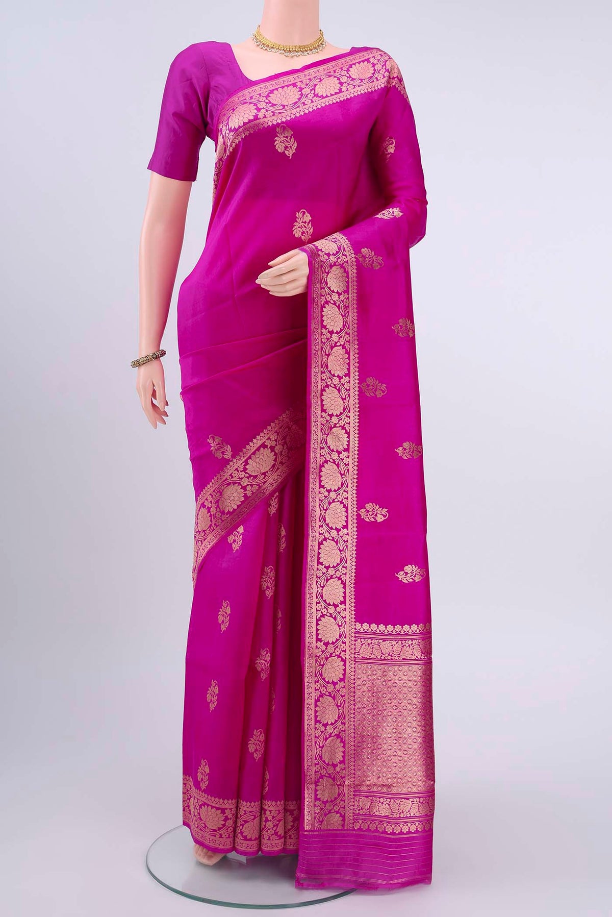 Rani Pink Banarasi Katan Silk Saree with Zari Butta on the body and Zari Border displayed on a mannequin