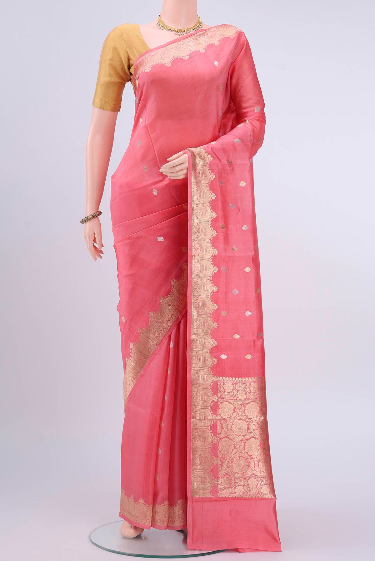 Peach Banarasi Katan Silk Saree with Zari Butta on the body and Zari Border displayed on a mannequin