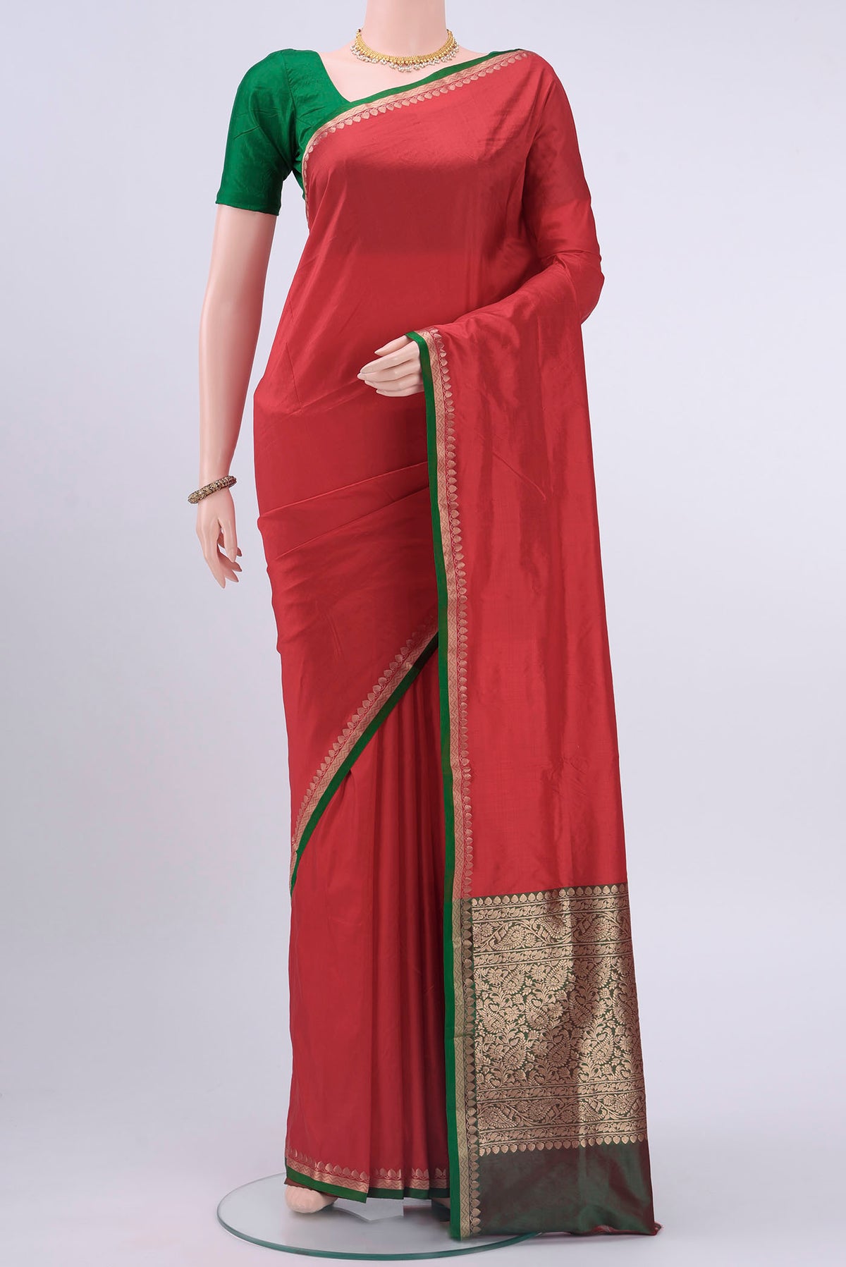 Red Banarasi Katan Silk Saree with Plain Body and Zari Border displayed on a mannequin