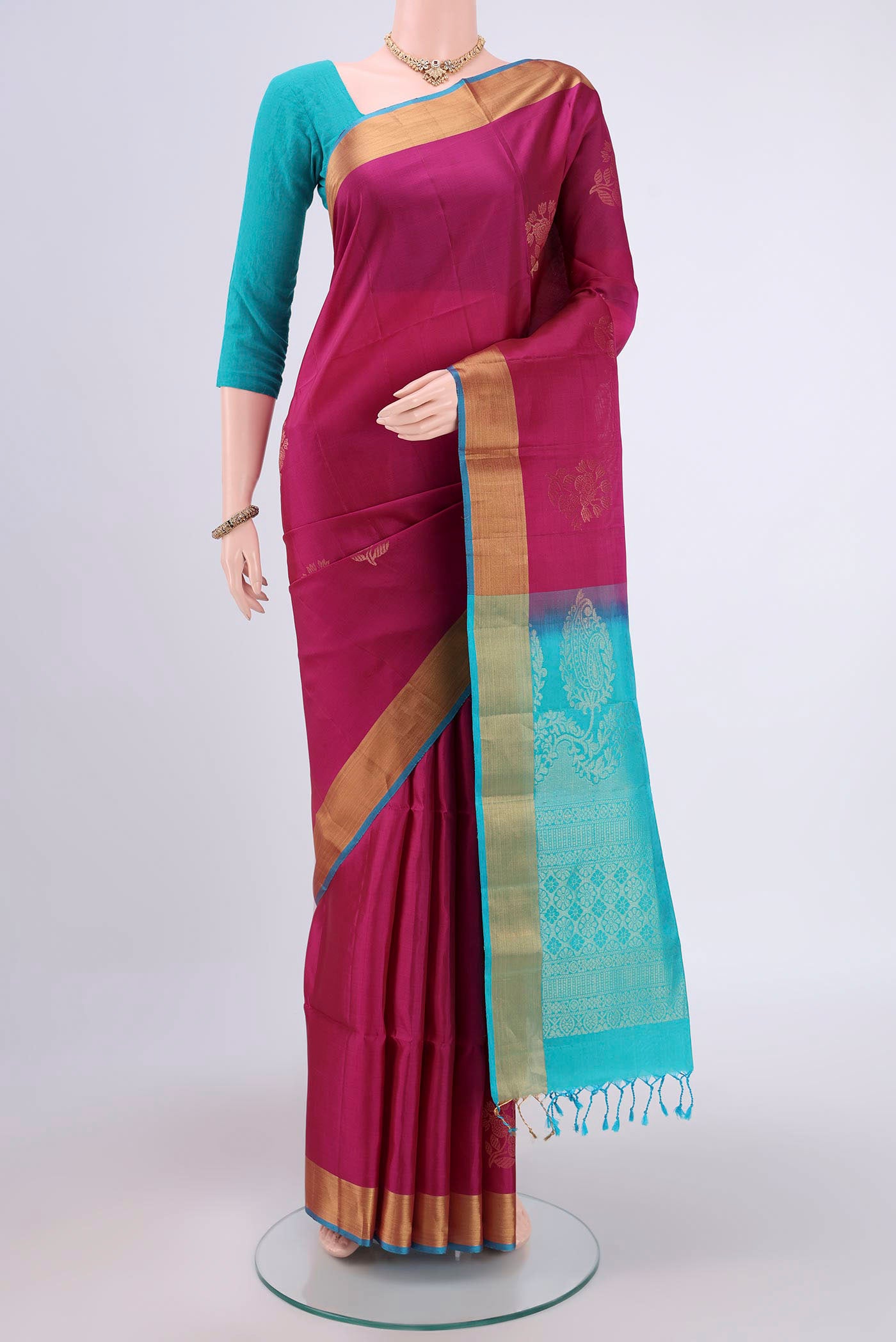 Magenta Soft Silk Saree with Zari Butta on the body and Zari Border.  displayed on a mannequin