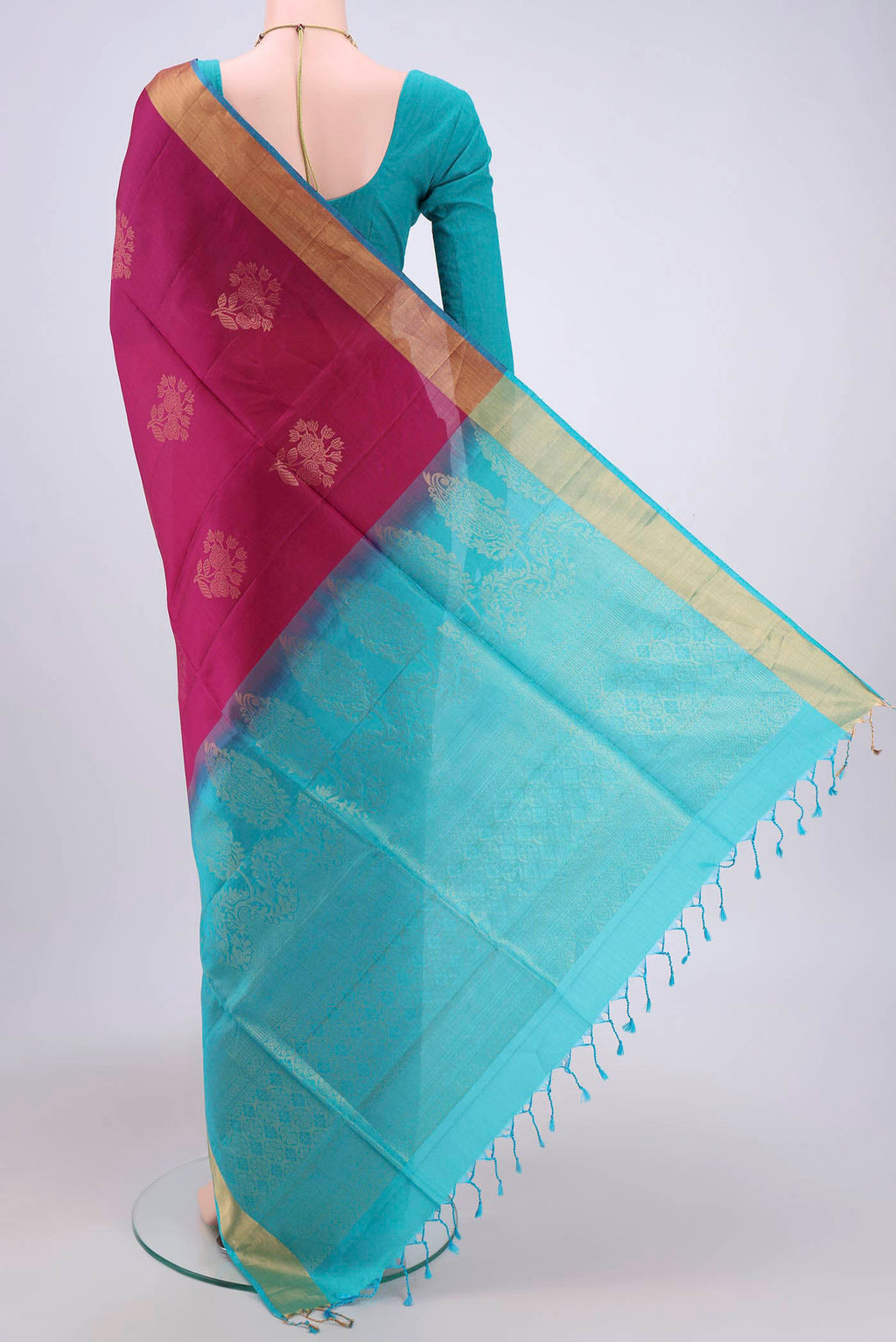 Flat view of Magenta Soft Silk Saree with Zari Butta on the body and Zari Border. 