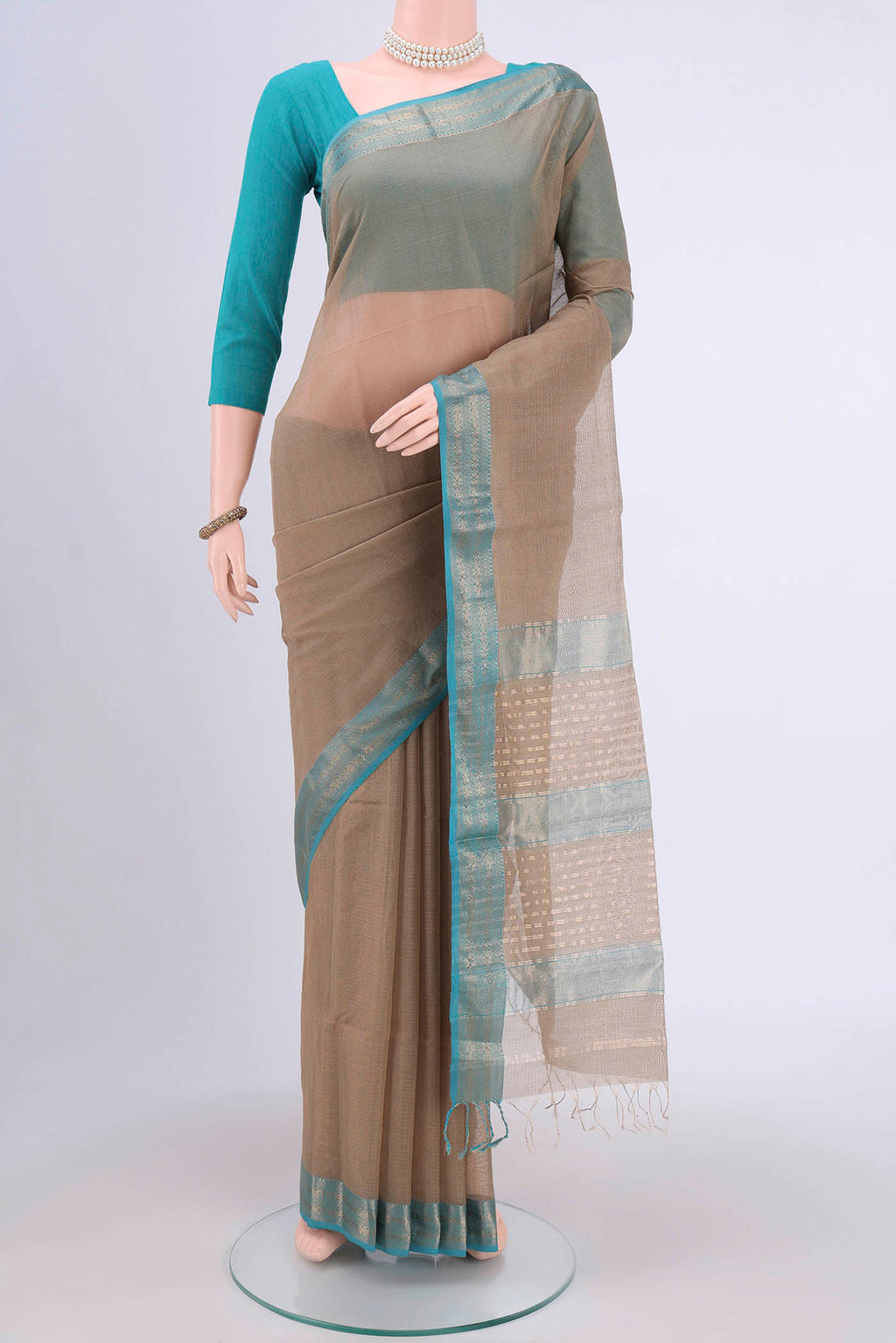 Dark Beige Maheshwari Silk Cotton Saree with Stripes on the body and Zari Border.  displayed on a mannequin
