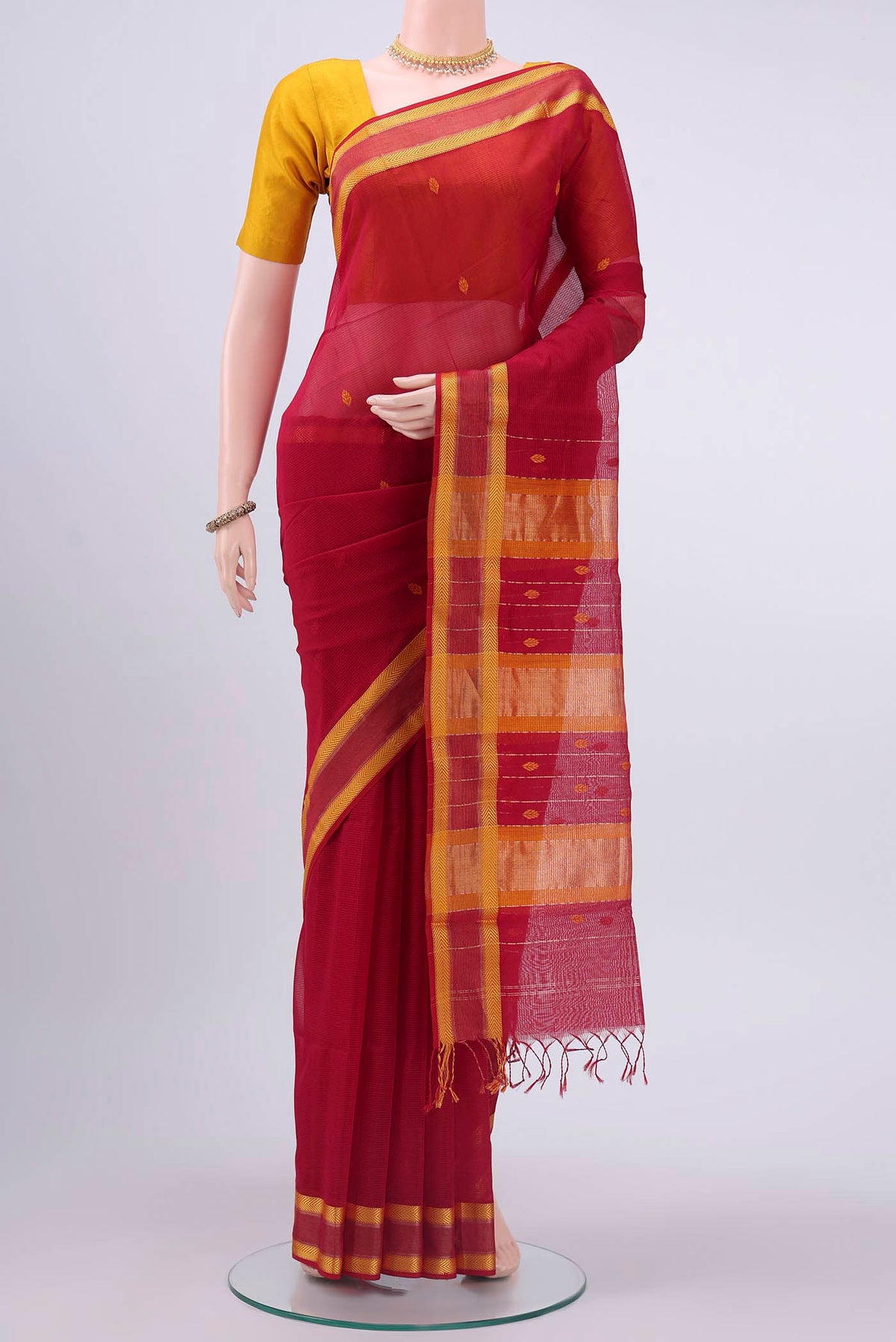 Red Maheshwari Silk Cotton Saree with Thread Butta on the body and Thread Border displayed on a mannequin