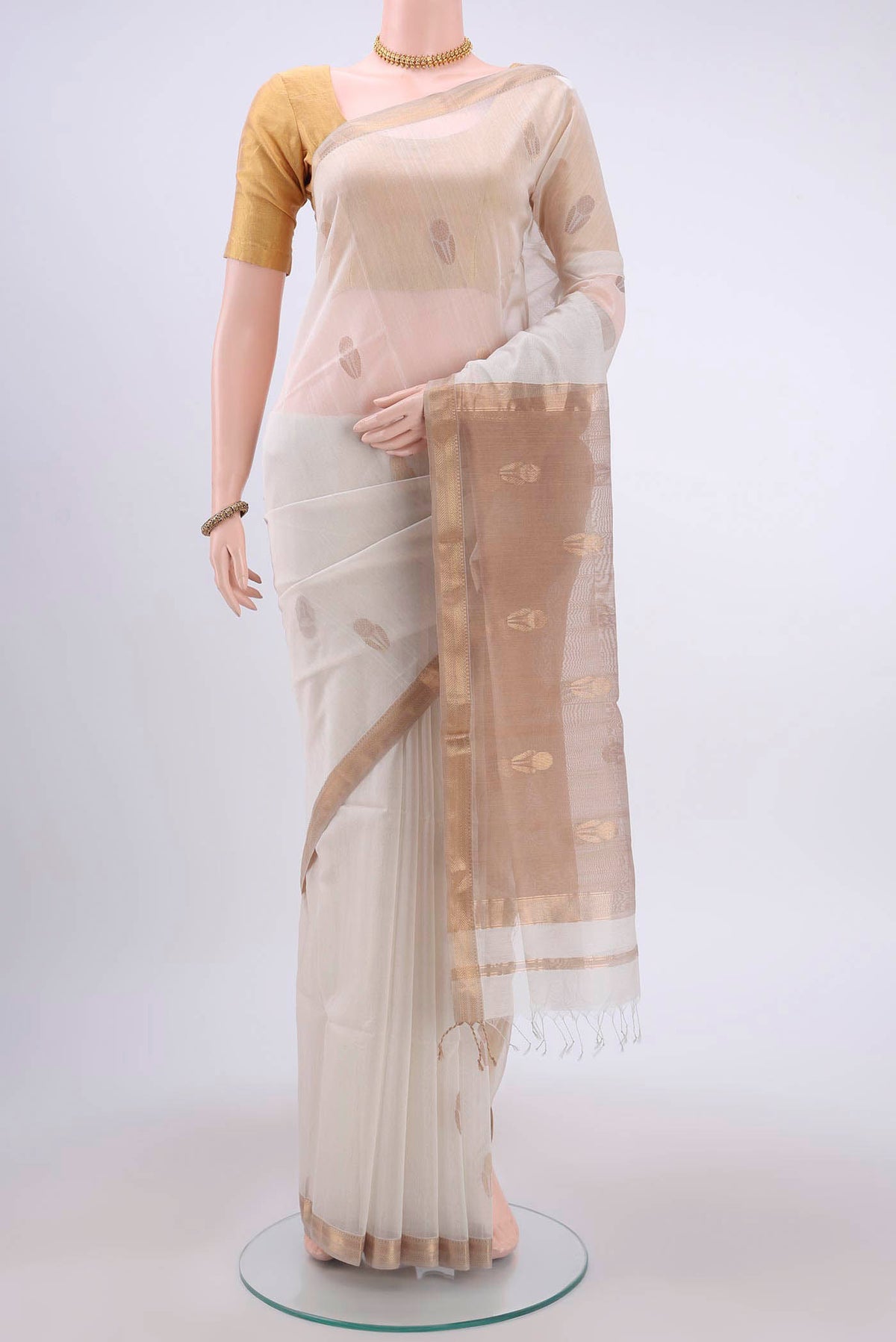 White Maheshwari Silk Cotton Saree with Zari Butta on the body and Zari Border displayed on a mannequin