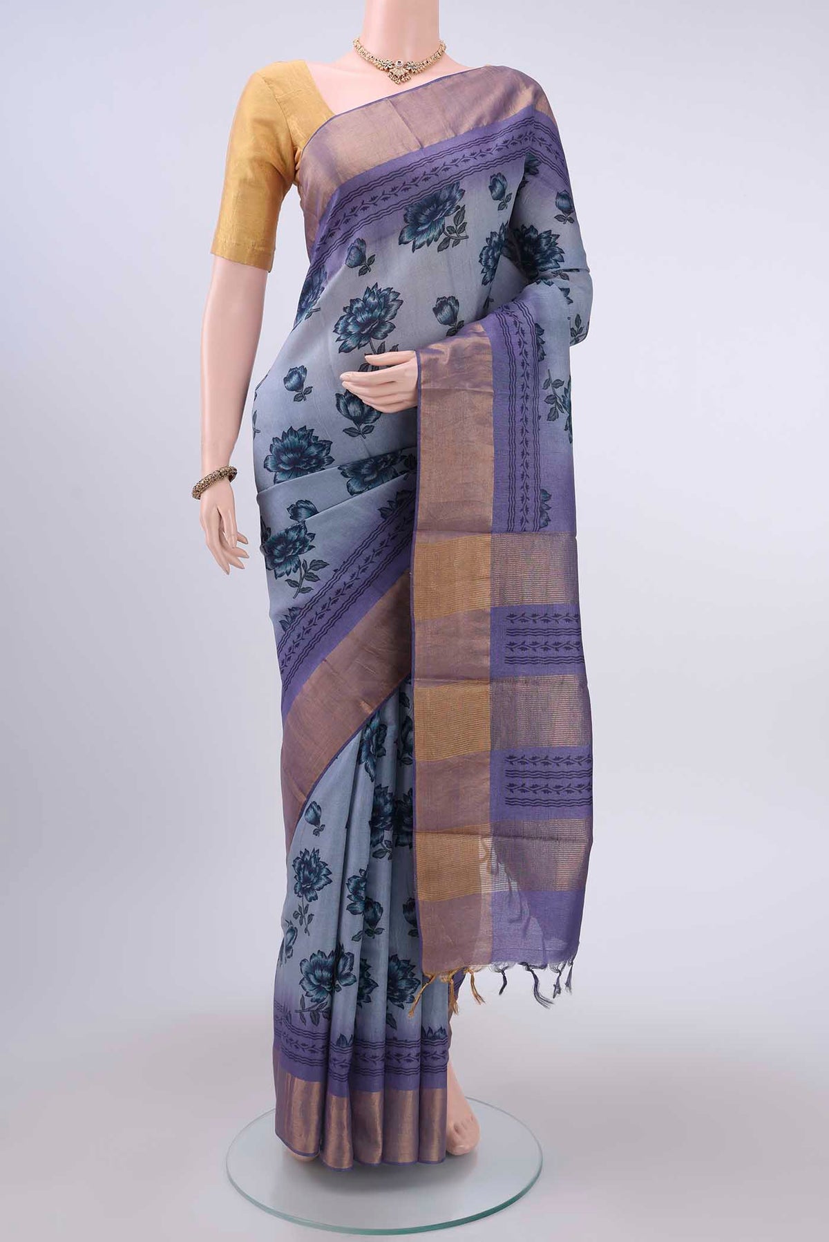 Light Blue Dual Tone Tussar Silk Saree with Printed design on the body and Zari Border displayed on a mannequin