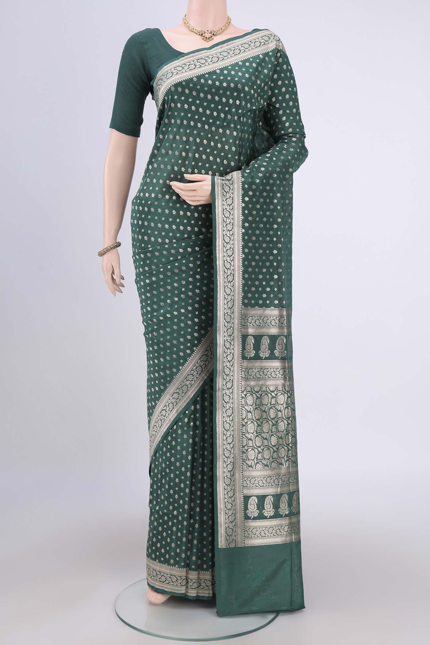 Green Banarasi Jamavar Saree with Zari Brocade on the body and Zari Border.  displayed on a mannequin