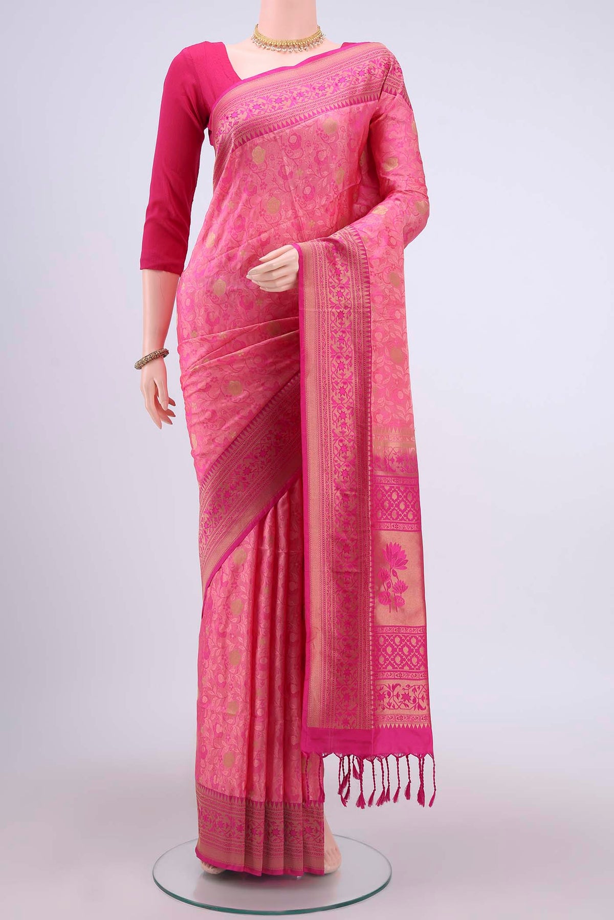 Rani Pink Soft Silk Saree with Jacquard design on the body and Zari Border displayed on a mannequin