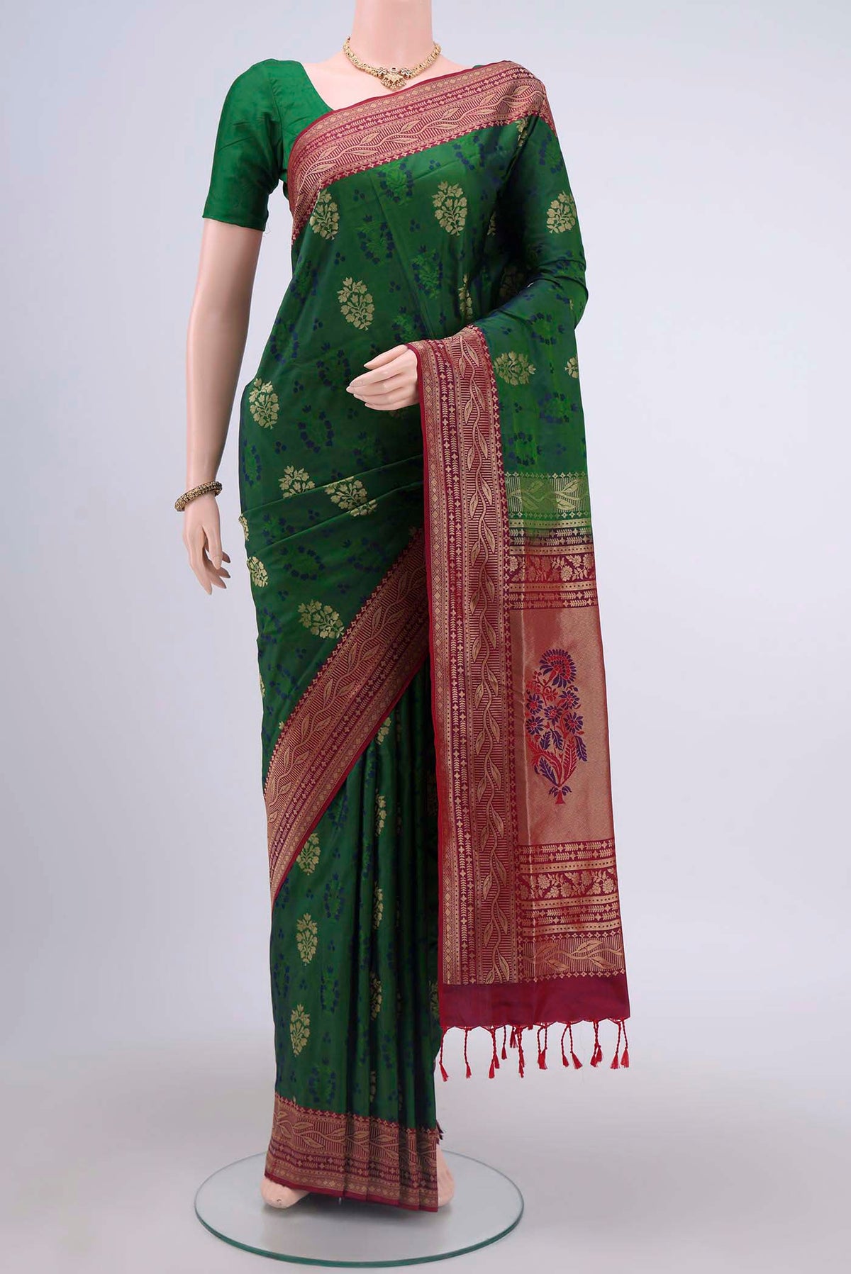 Green Soft Silk Saree with Jacquard design on the body and Zari Border displayed on a mannequin