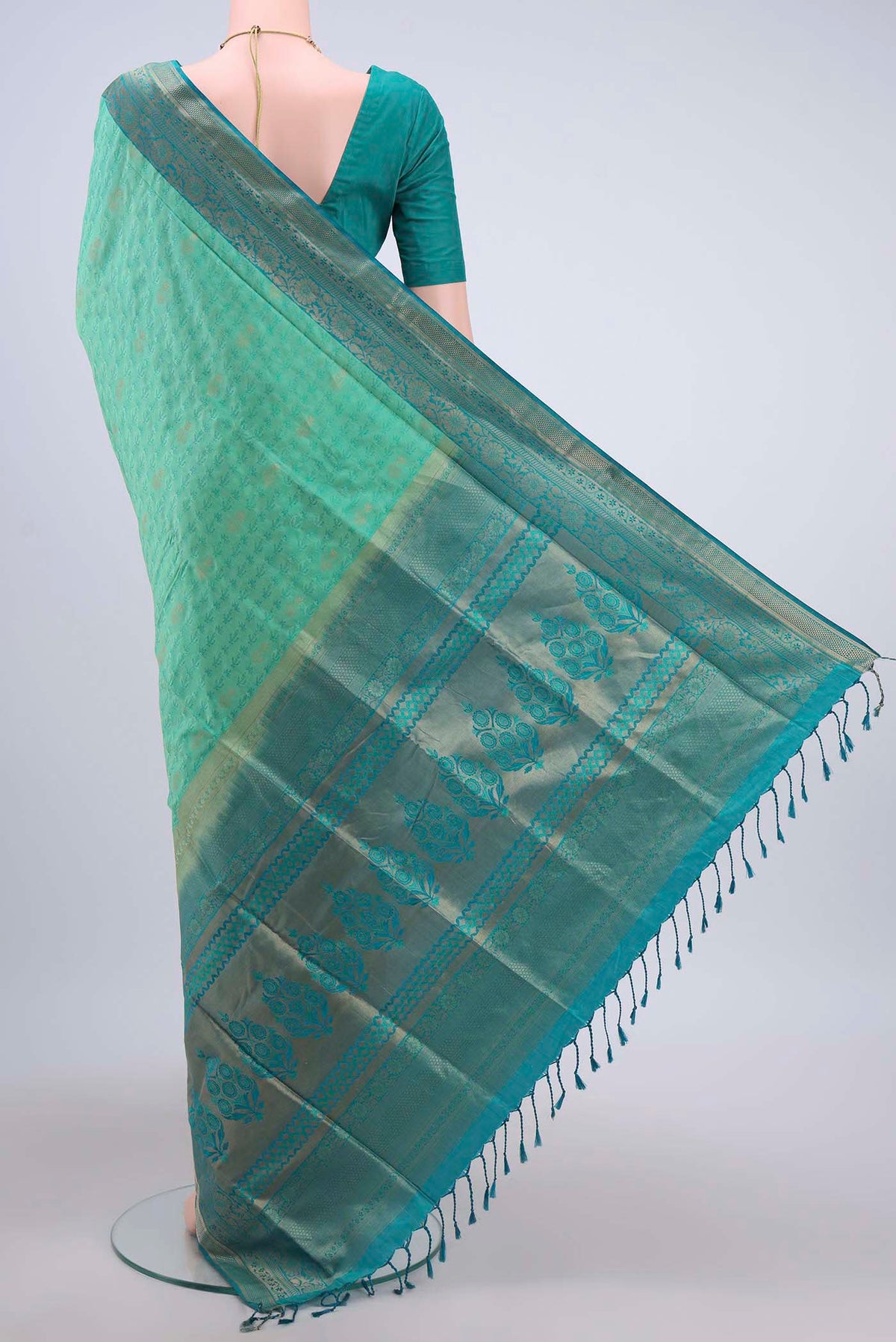 Flat view of Turquoise Soft Silk Saree with Jacquard design on the body and Zari Border